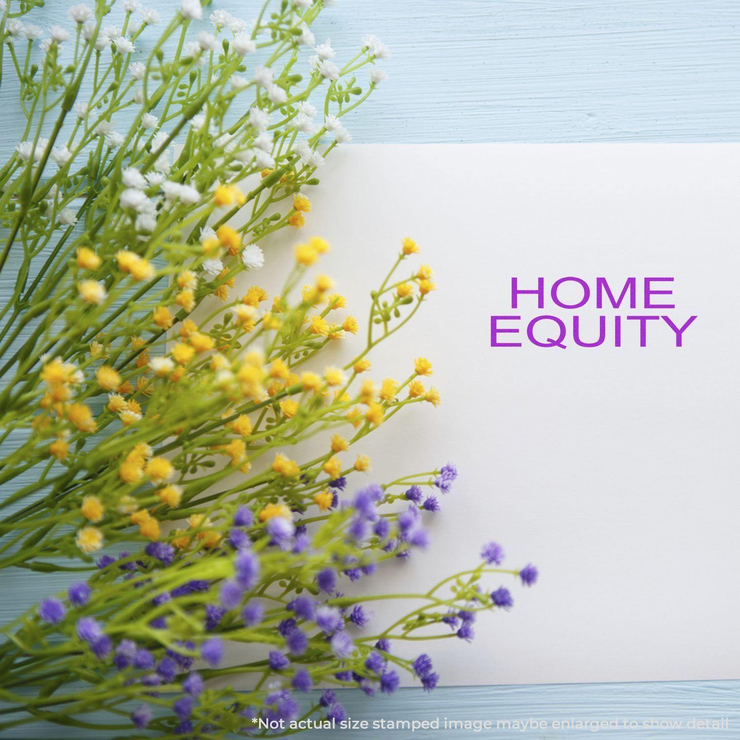 Large Self Inking Home Equity Stamp used on white paper, surrounded by yellow, white, and purple flowers on a light blue wooden surface.