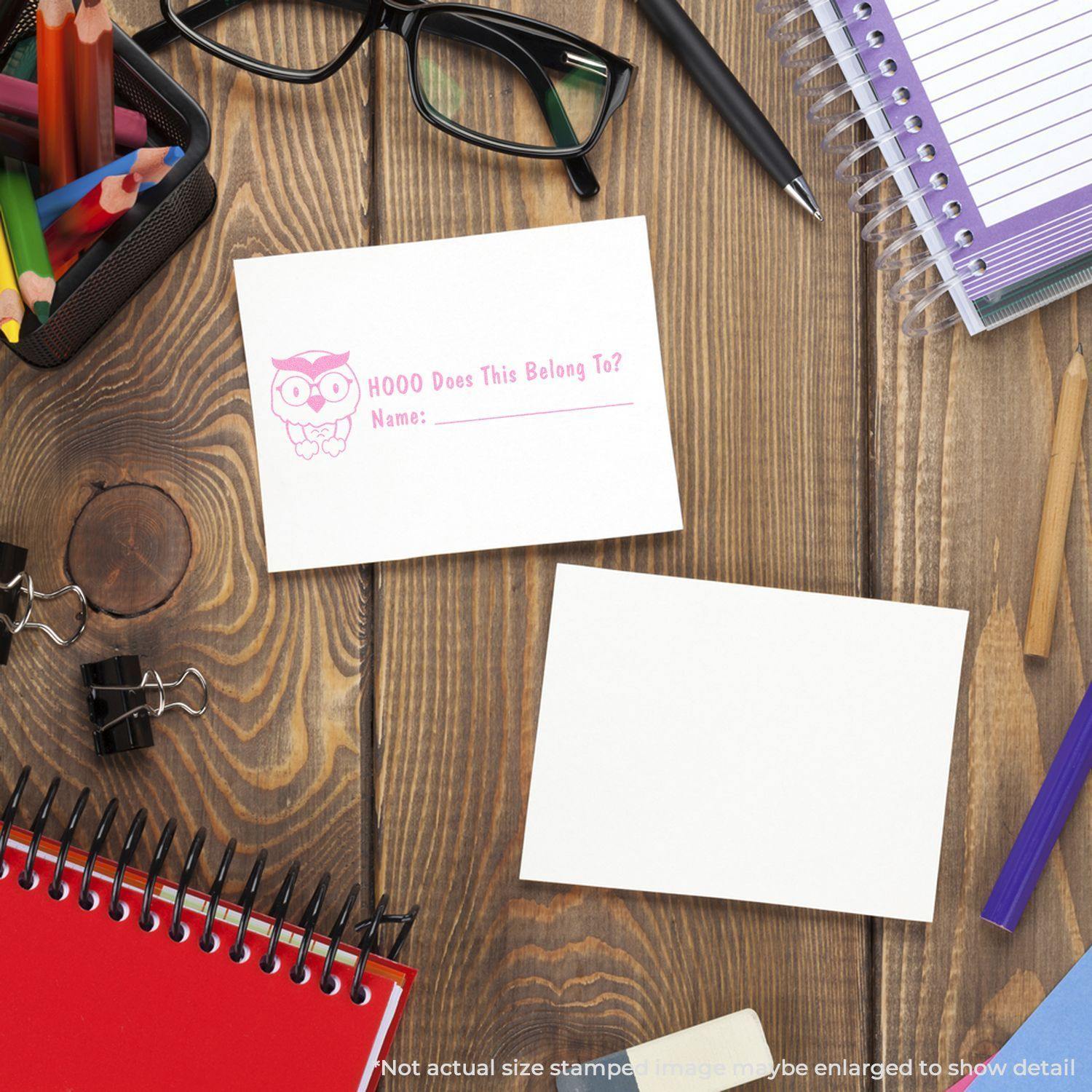 Desk with office supplies and a stamped card reading HOOO Does This Belong To? using the Large Self Inking Hooo does this belong to Stamp.