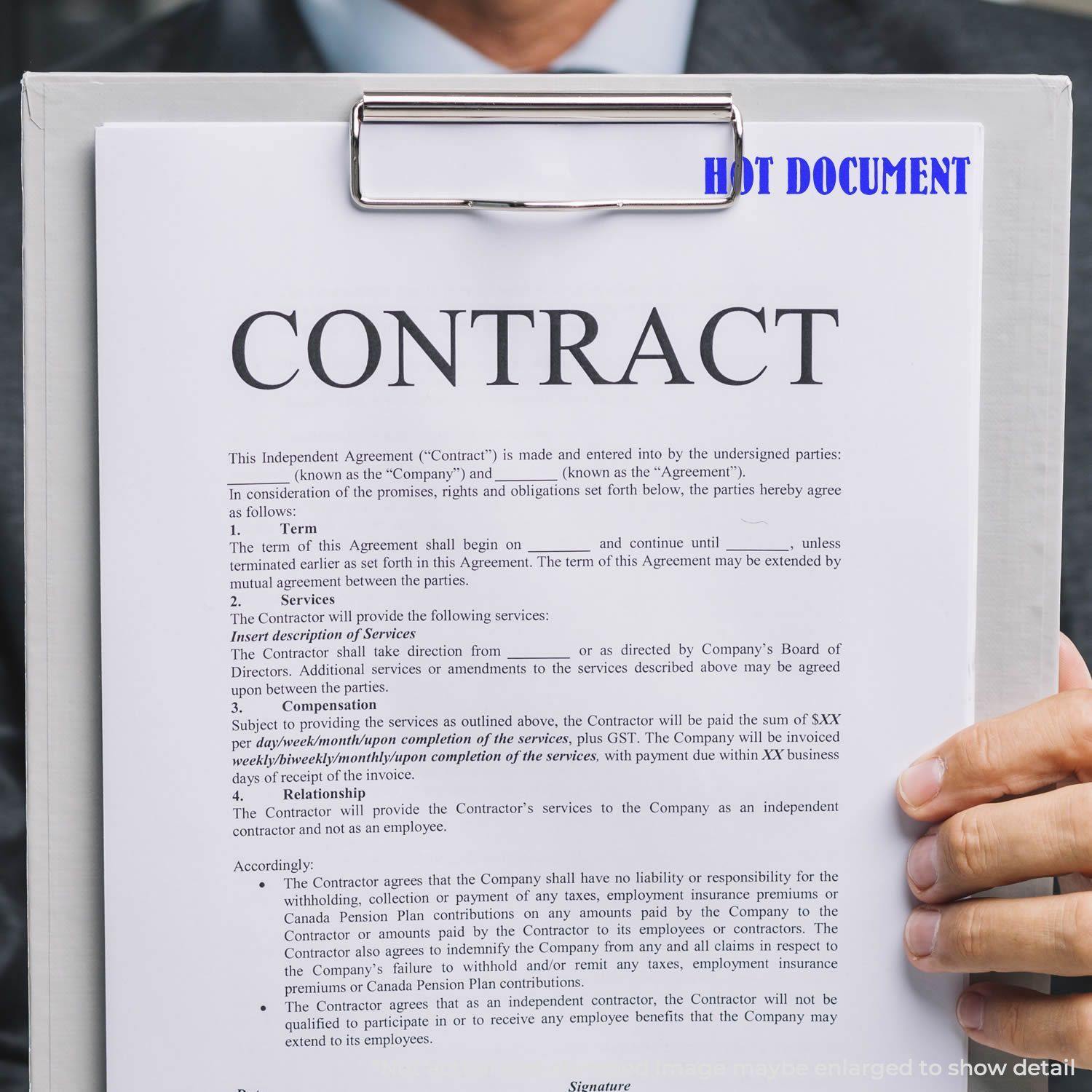 A person holding a clipboard with a contract stamped HOT DOCUMENT using the Self Inking Hot Document Stamp.