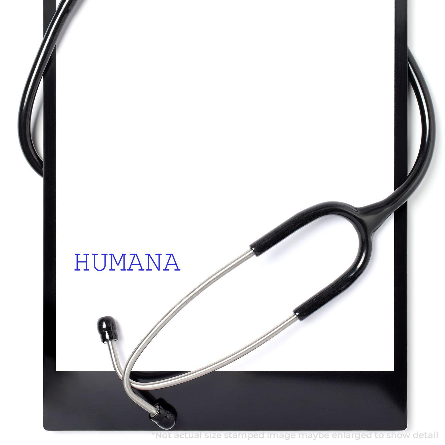 Large Self Inking Humana Stamp imprint on a white paper with a stethoscope on a black clipboard.