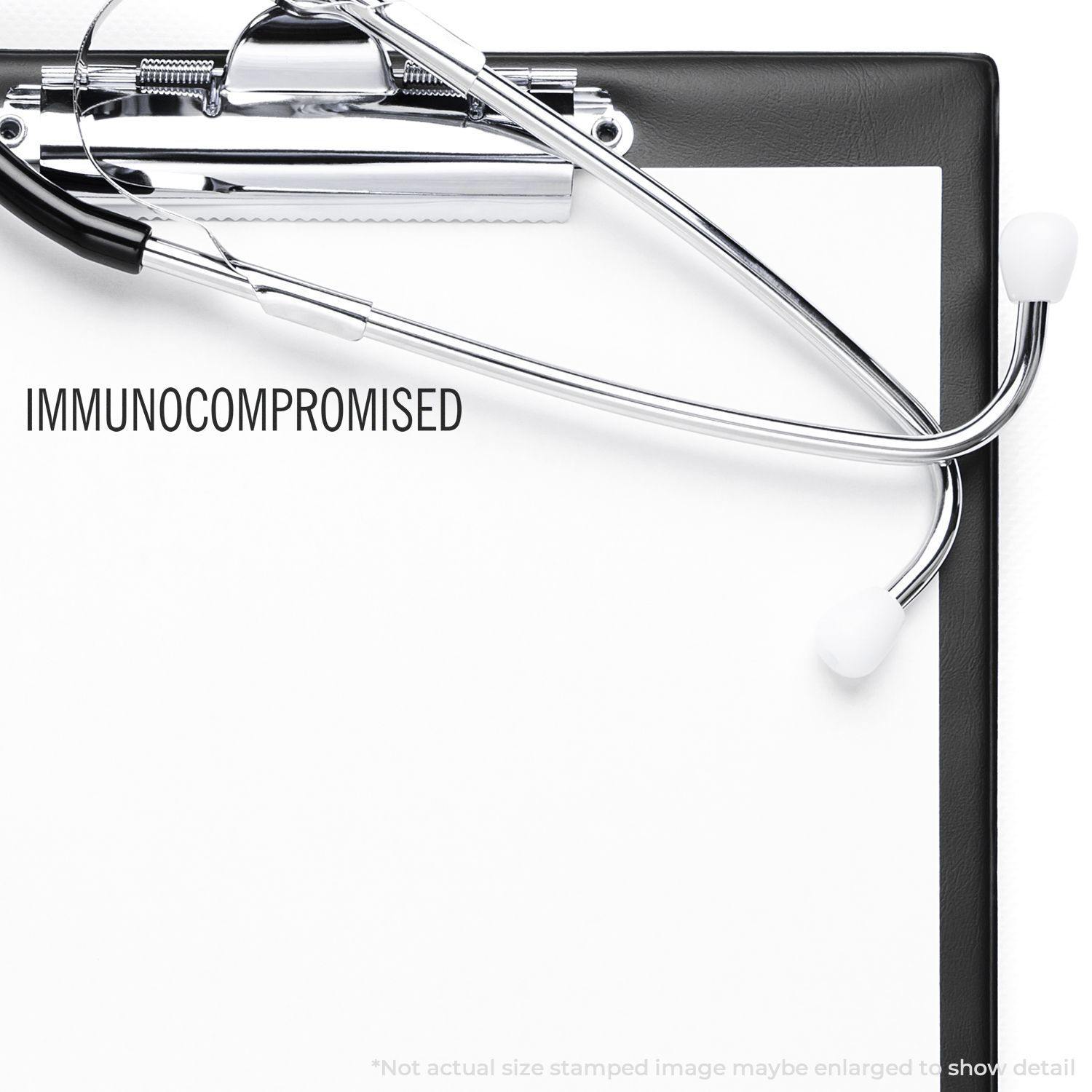 A clipboard with a stethoscope and a stamped paper reading IMMUNOCOMPROMISED using the Immunocompromised Rubber Stamp.