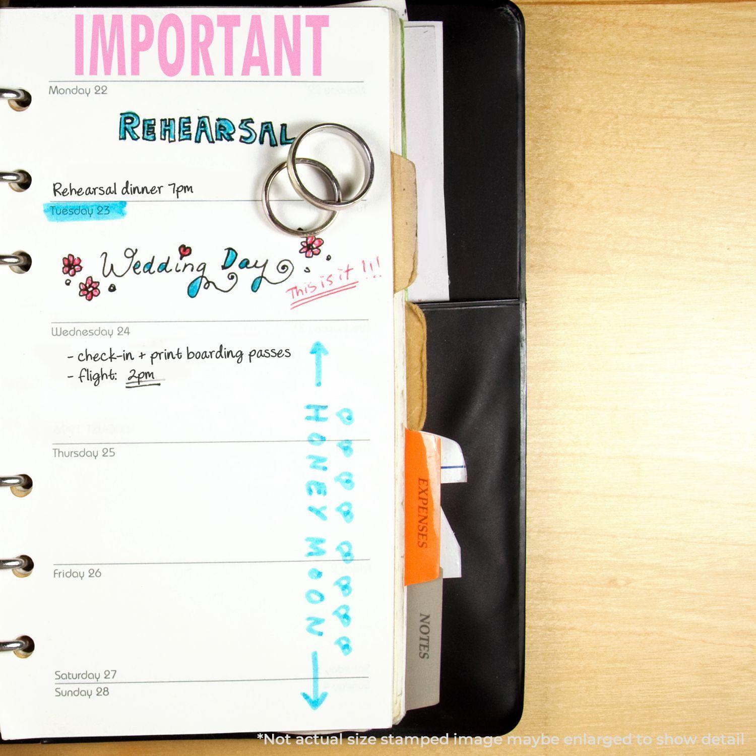 Open planner with notes and rings, featuring the Self Inking Important Stamp marking IMPORTANT in pink at the top of a page.