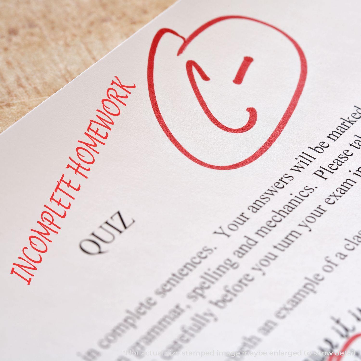 Slim Pre-Inked Incomplete Homework Stamp in red ink on a quiz paper, indicating incomplete homework with a smiley face.