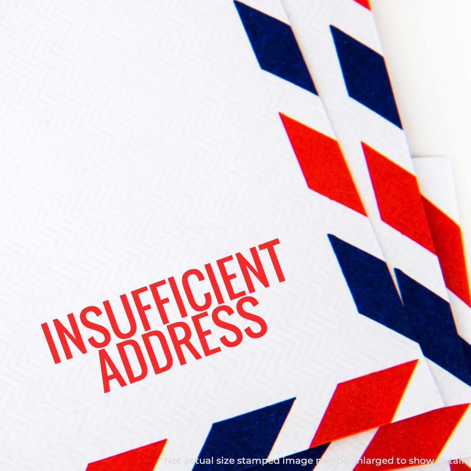 Slim Pre-Inked Insufficient Address Stamp used on an envelope with red and blue chevron border design.