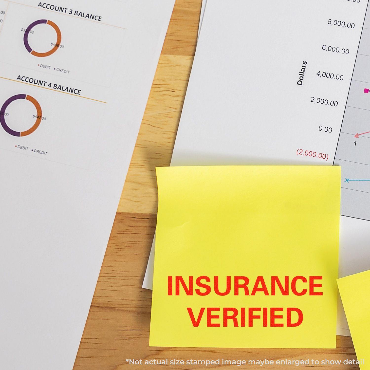 Insurance Verified Rubber Stamp in red ink on a yellow sticky note, placed on a desk with financial documents and charts in the background.