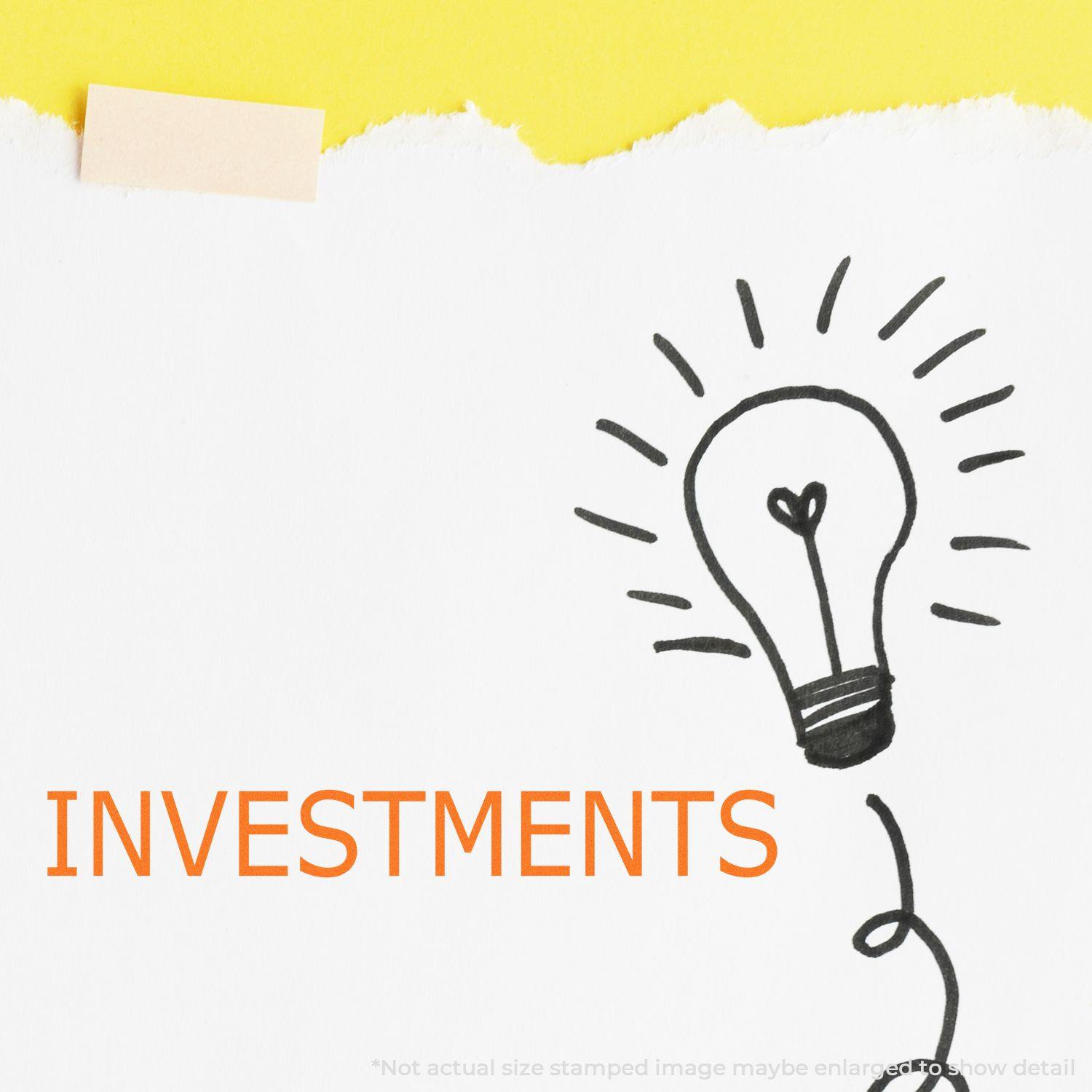 Image of the Investments Rubber Stamp in use, showing the word INVESTMENTS stamped in orange next to a hand-drawn light bulb on paper.