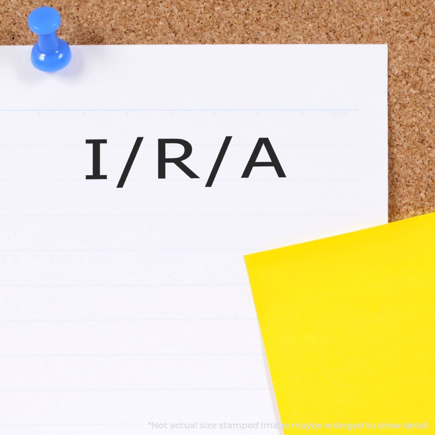 Self Inking Ira Stamp used on a white paper pinned to a corkboard, with a yellow sticky note partially visible.