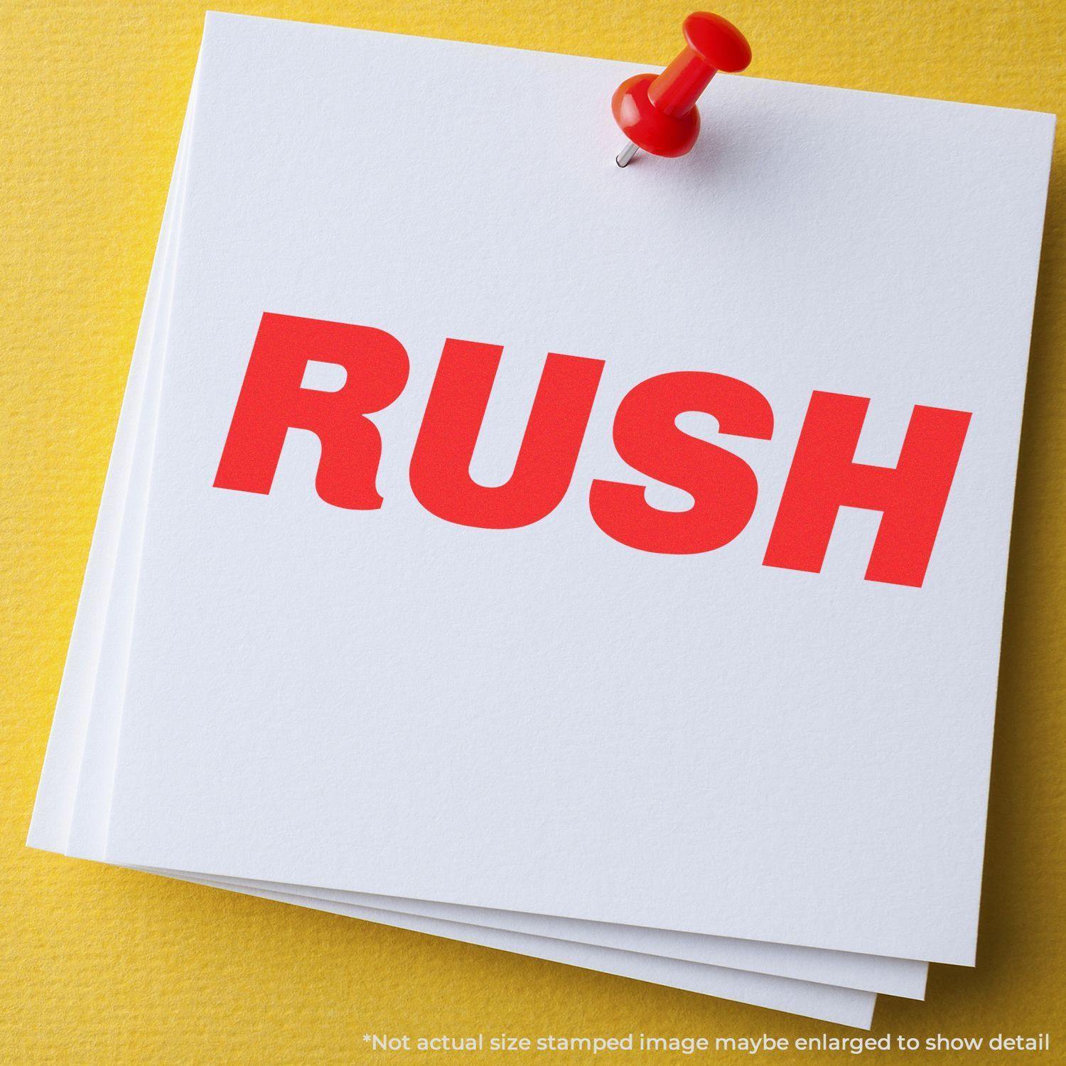 Large Self Inking Italic Rush Stamp in red ink on white paper pinned to a yellow board.