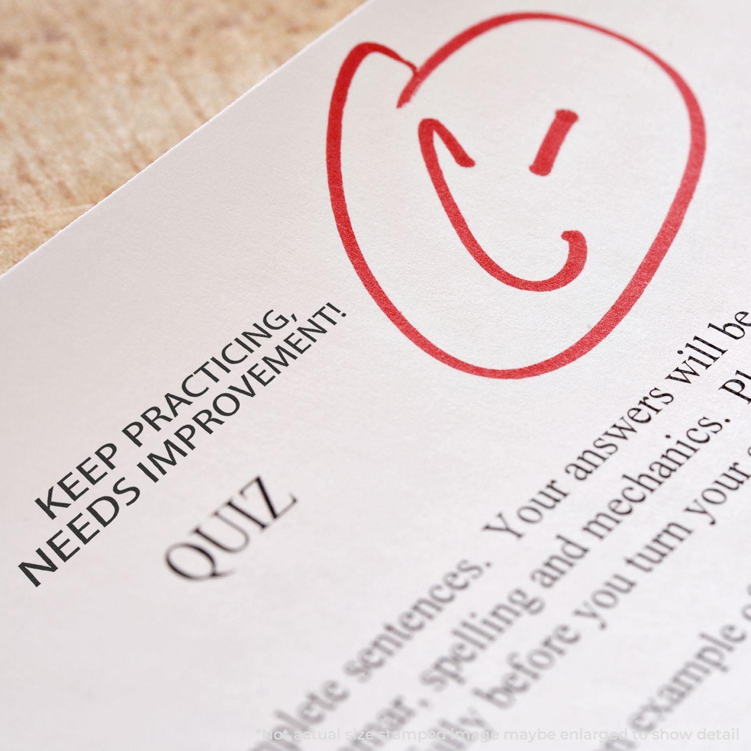 A paper with a red smiley face and the Keep Practicing Needs Improvement Rubber Stamp marking next to the word QUIZ.