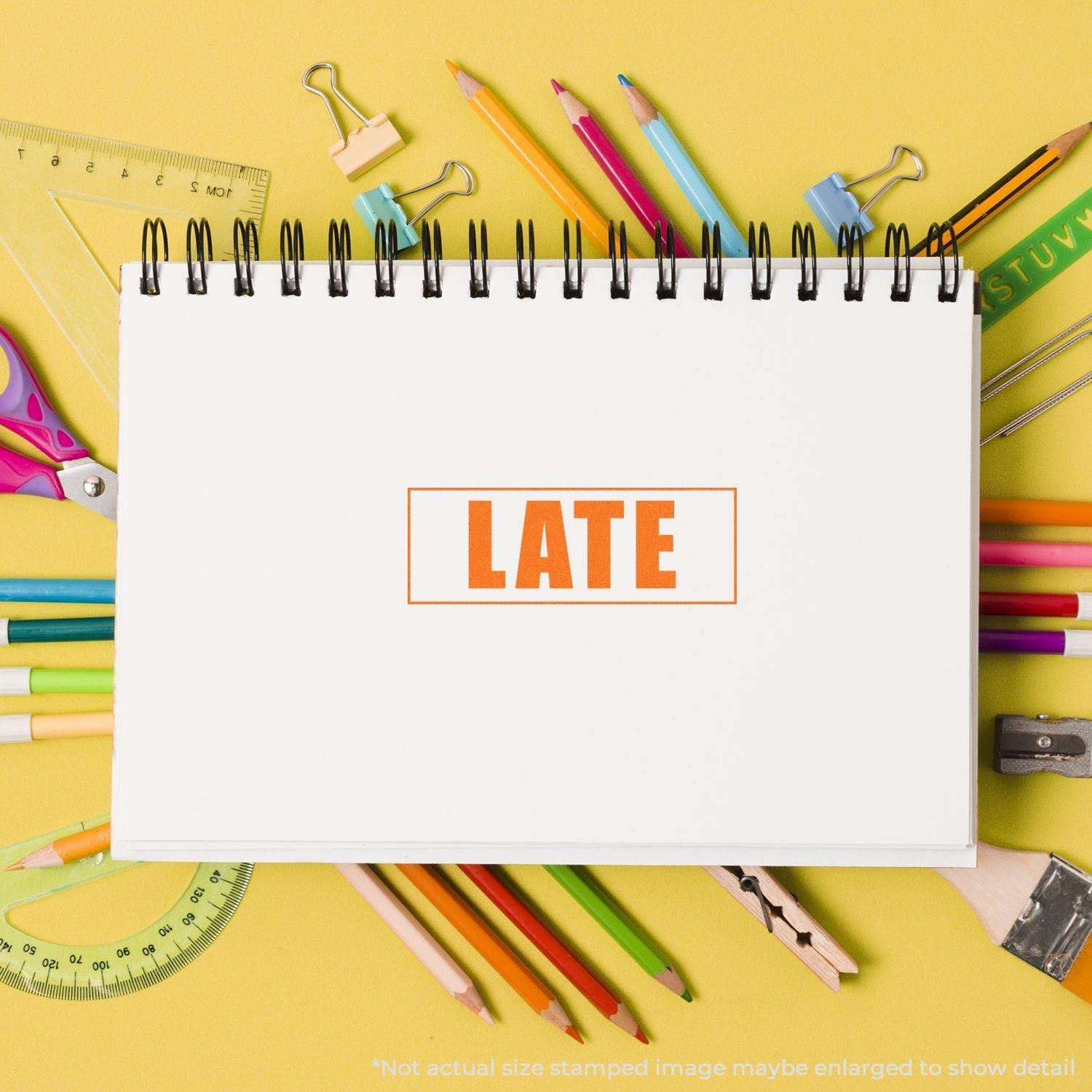 Late with Border Rubber Stamp marked on a white notebook, surrounded by colorful stationery on a yellow background.