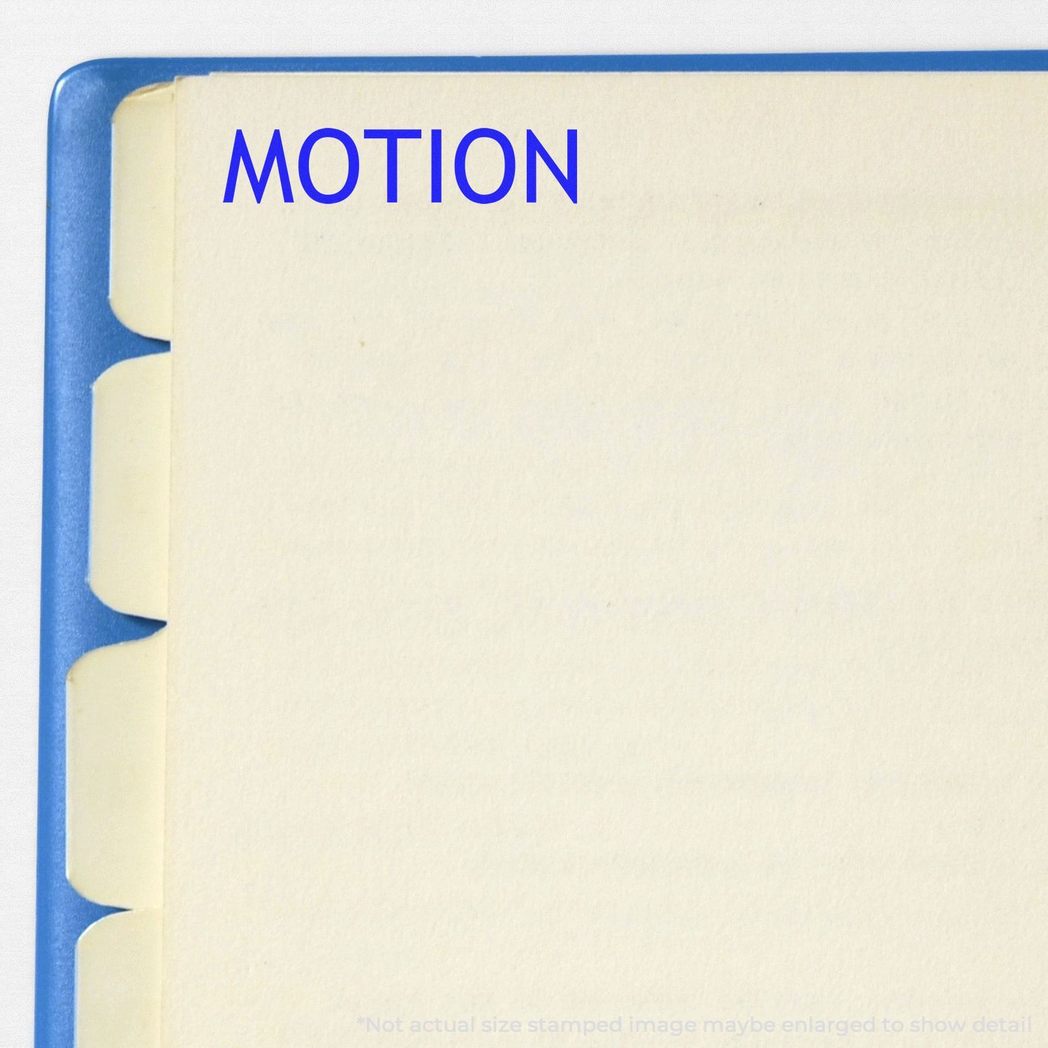 Self Inking Motion Stamp in use, stamping the word MOTION in blue ink on a page with tabbed dividers.