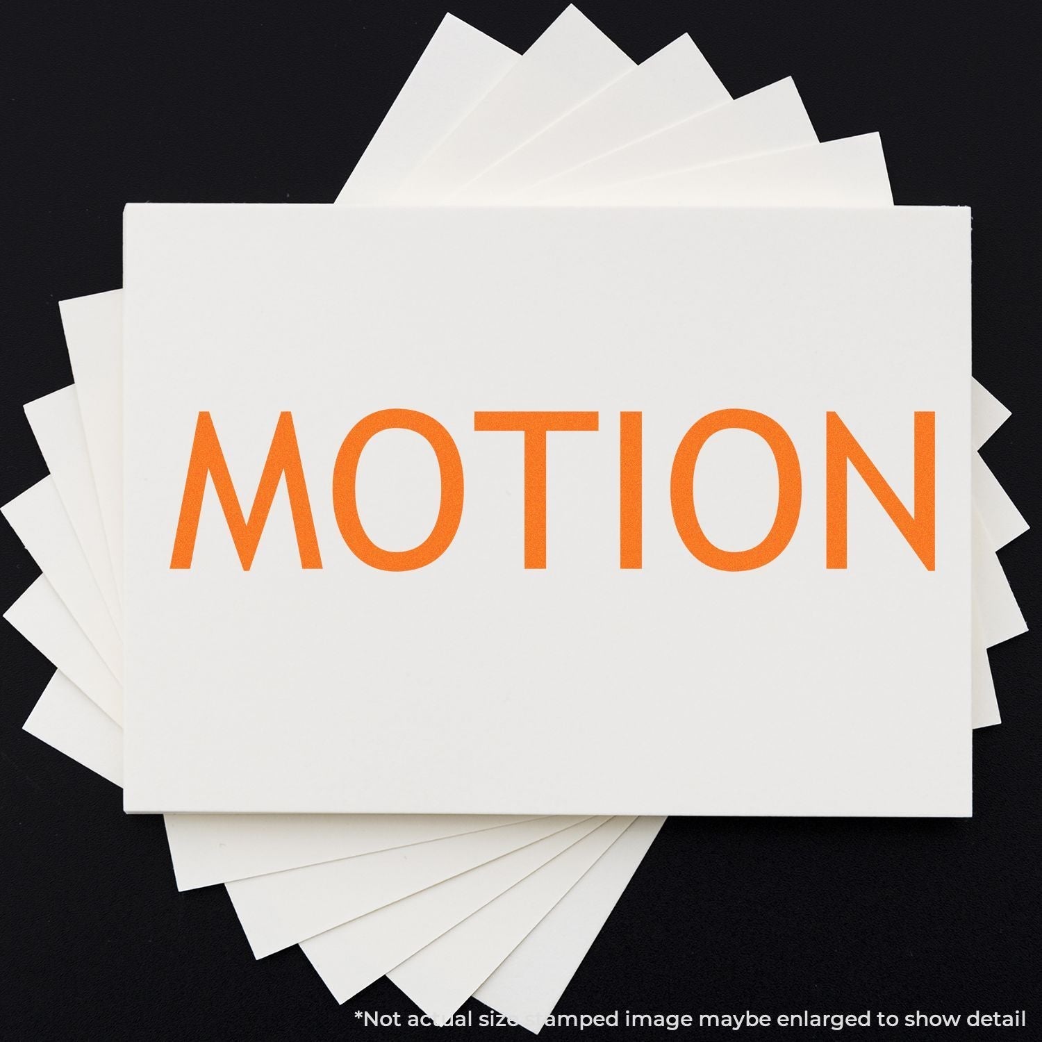 Self Inking Motion Stamp in use, displaying the word MOTION in bold orange letters on white paper, with multiple stamped sheets shown.