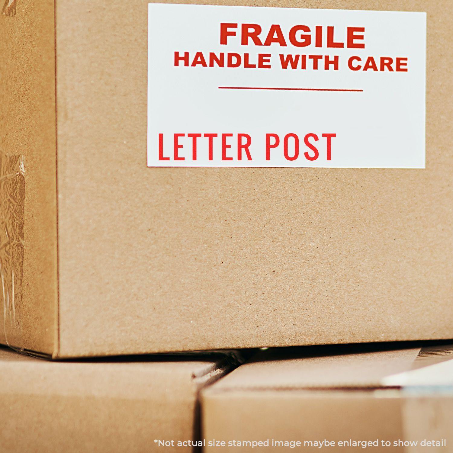 Cardboard boxes with a FRAGILE HANDLE WITH CARE and LETTER POST label, stamped using the Large Letter Post Rubber Stamp.