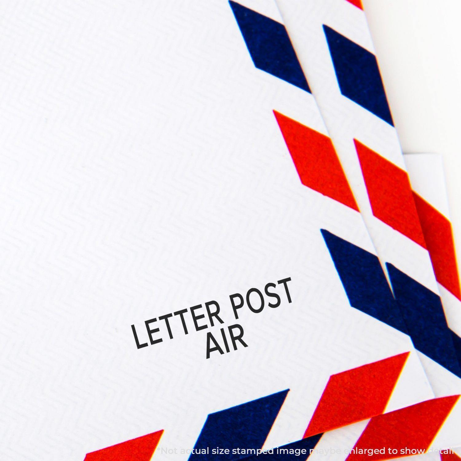 Envelopes with red and blue border patterns stamped with LETTER POST AIR using a rubber stamp.