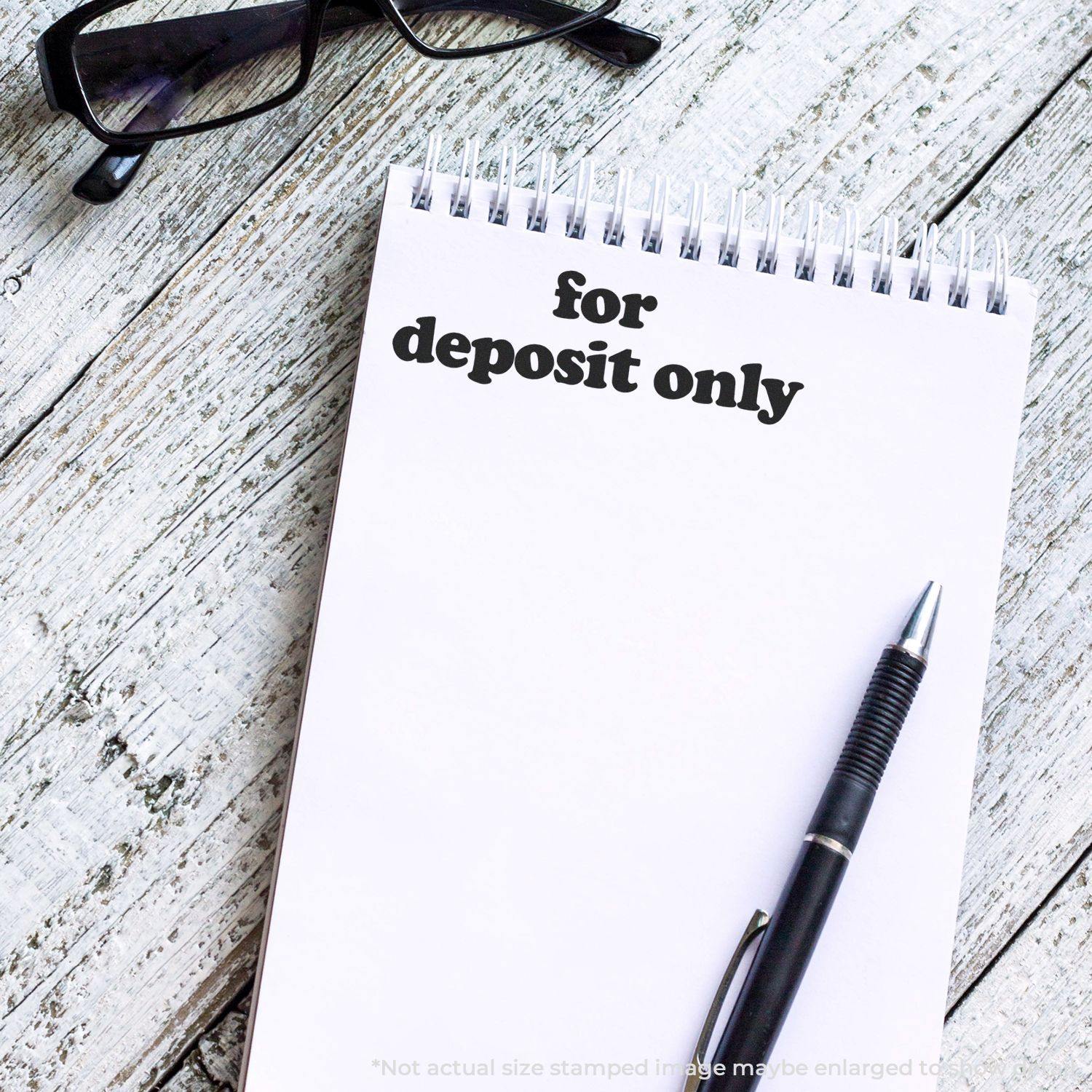 Large Lowercase For Deposit Only Rubber Stamp used on a white notepad with a pen and glasses on a wooden surface.