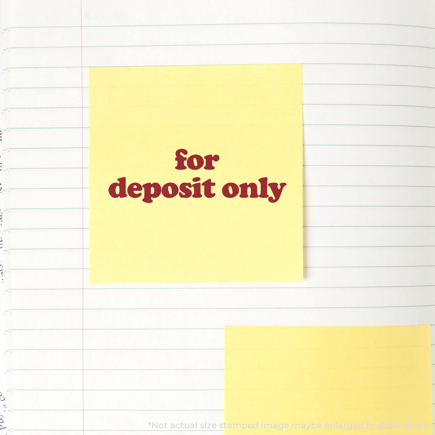 Slim Pre-Inked Lowercase For Deposit Only Stamp used on a yellow sticky note placed on a lined notebook page.