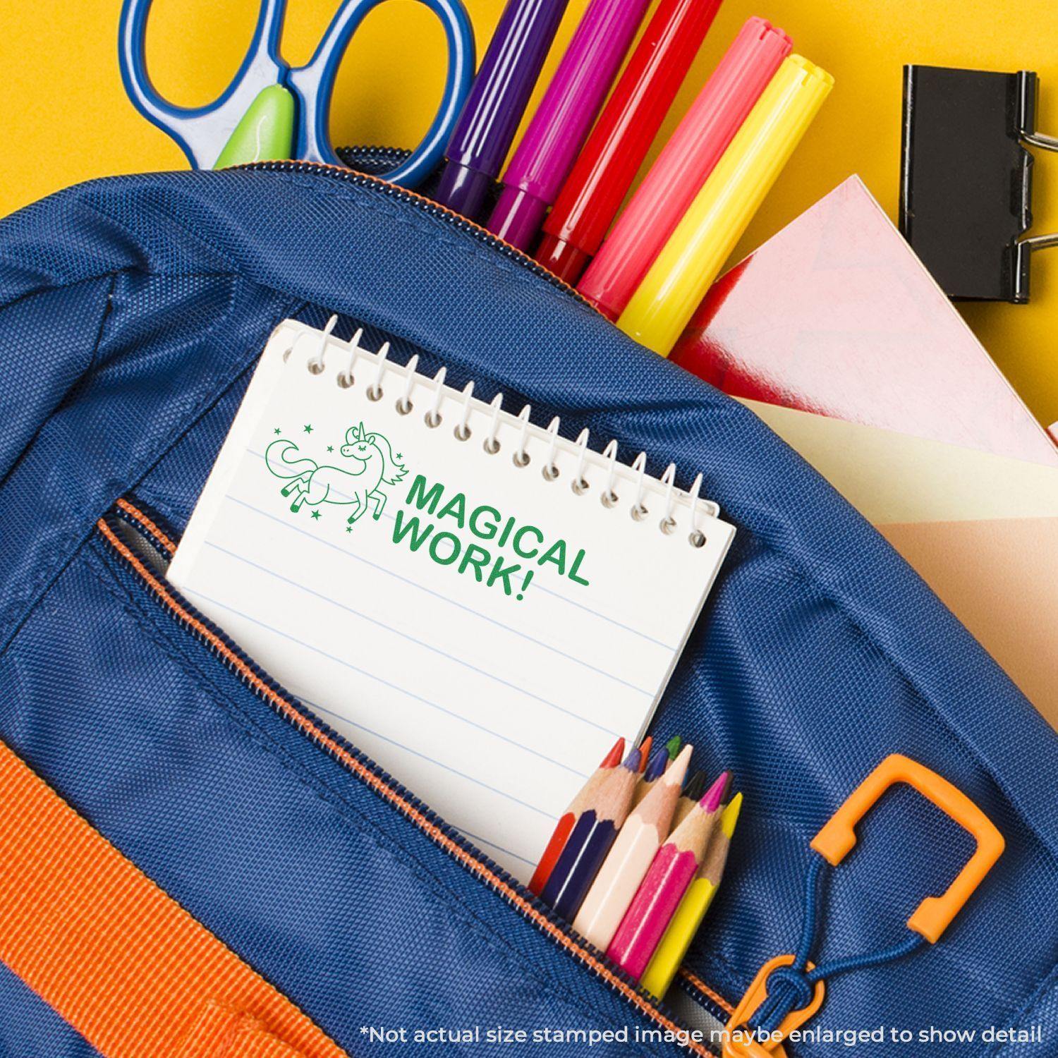 A blue backpack with colored pencils, markers, and a notebook stamped with MAGICAL WORK! using the Large Magical Work Rubber Stamp.