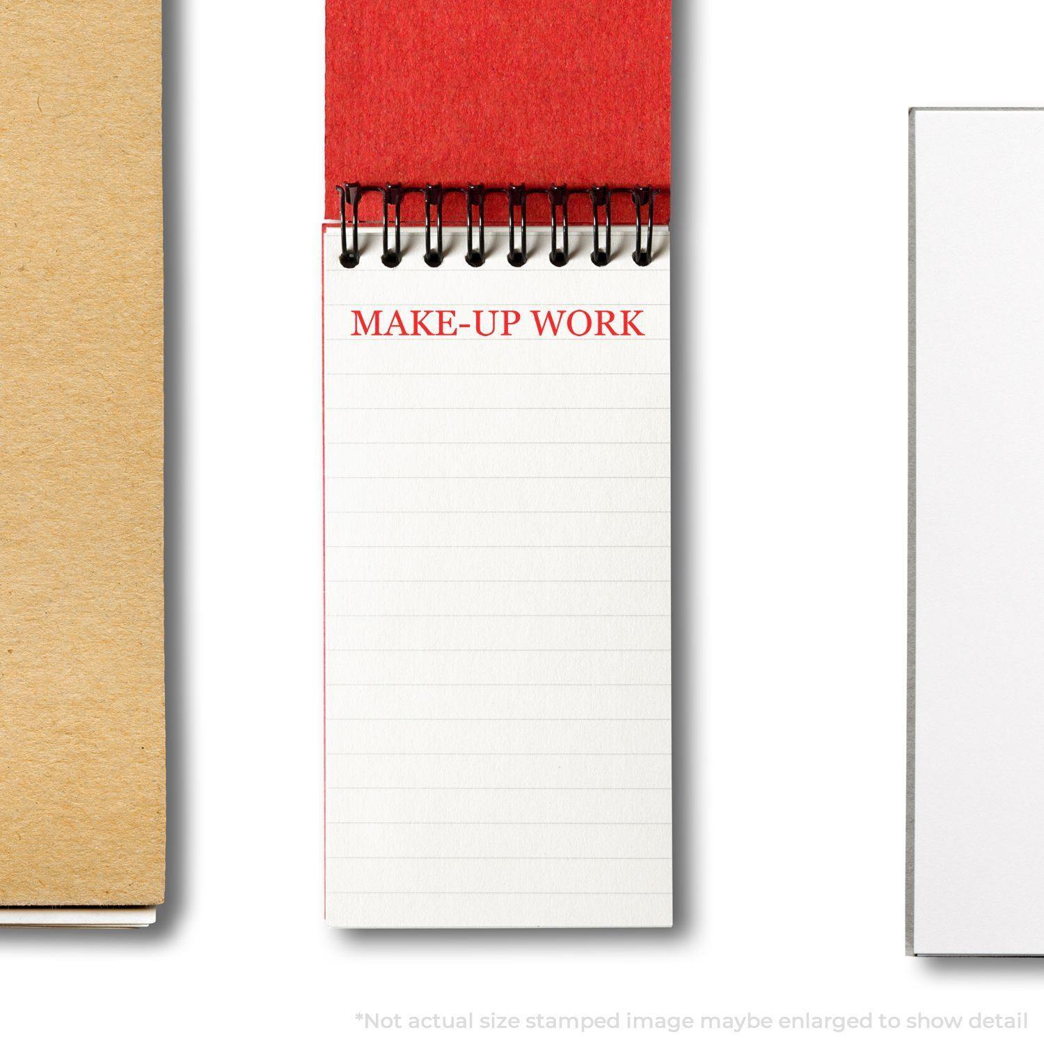 A notebook with MAKE-UP WORK stamped in red using the Large Make Up Work Rubber Stamp, shown on a white page with a red cover.