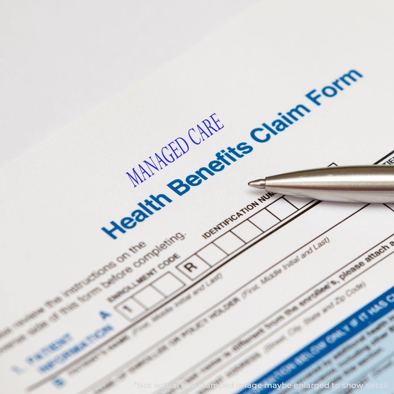 A Large Managed Care Rubber Stamp marks a health benefits claim form, with a pen pointing at the identification number section.