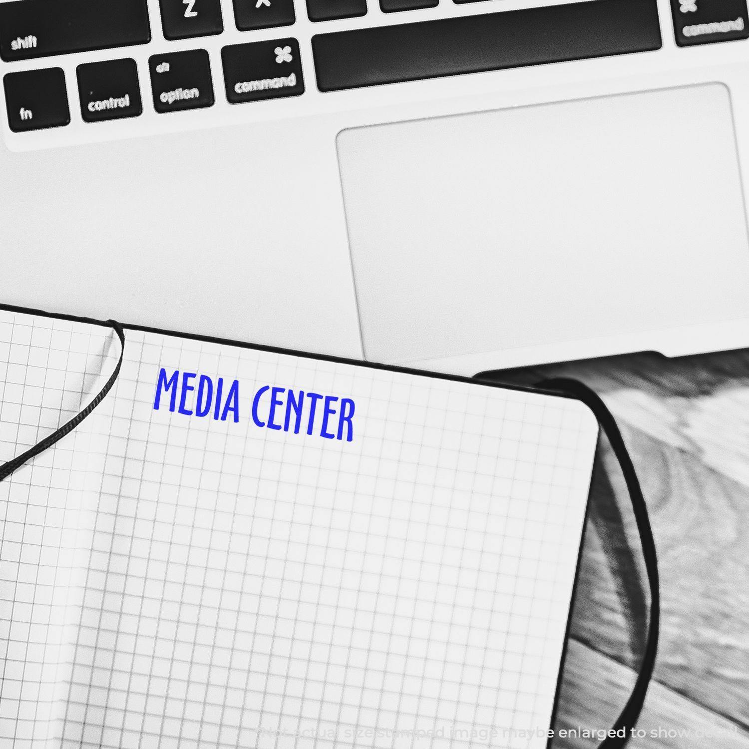 Large Media Center Rubber Stamp used on a notebook page, with a laptop keyboard partially visible in the background.