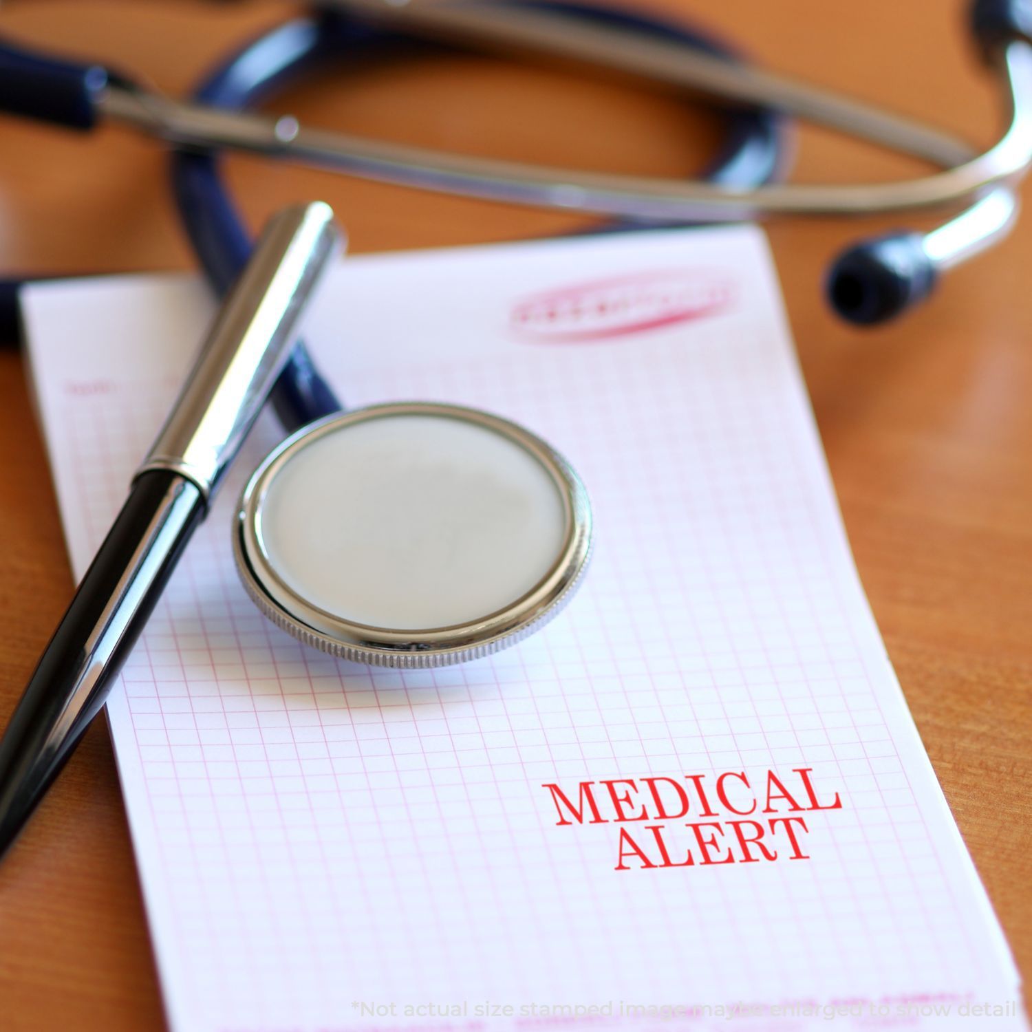 Self Inking Medical Alert Stamp imprint on a notepad with a stethoscope and pen on a wooden desk.