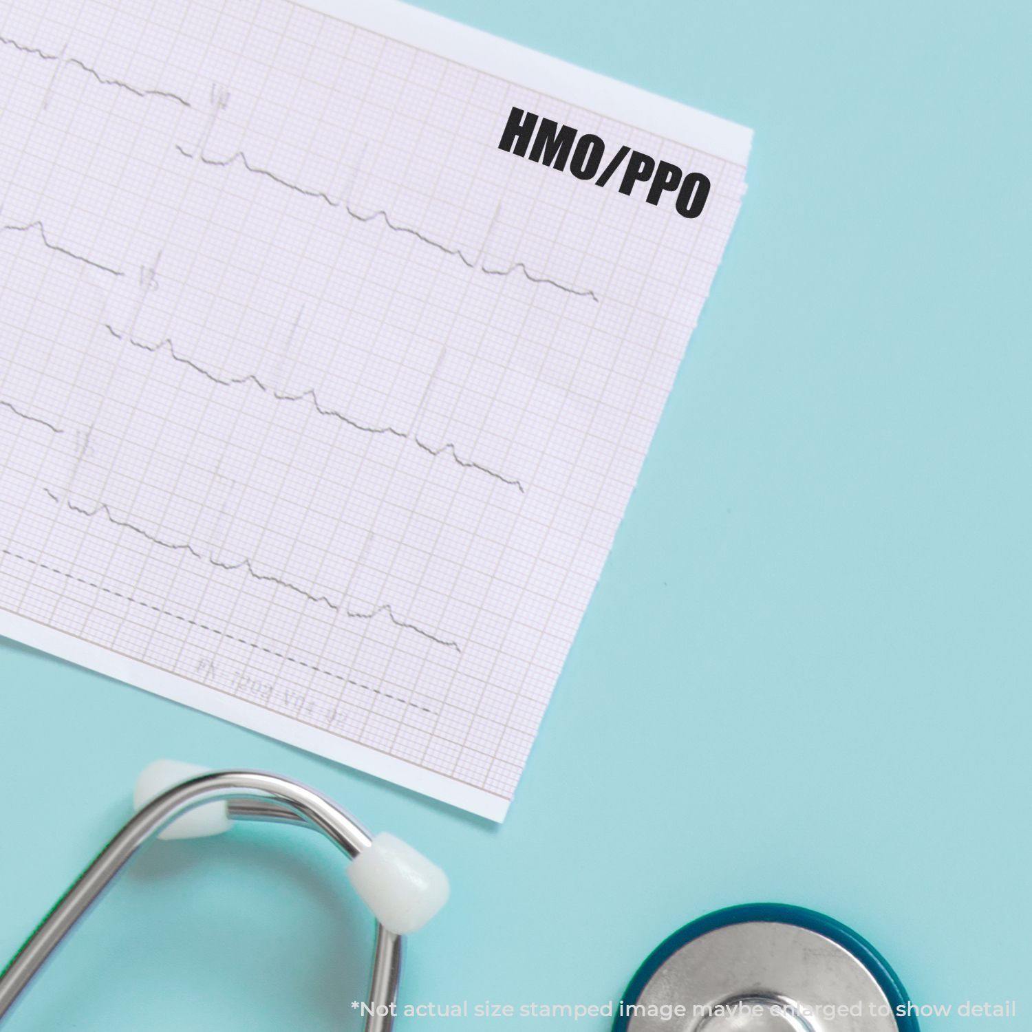 Self Inking HMO/PPO Stamp used on medical document with stethoscope nearby on a light blue background.