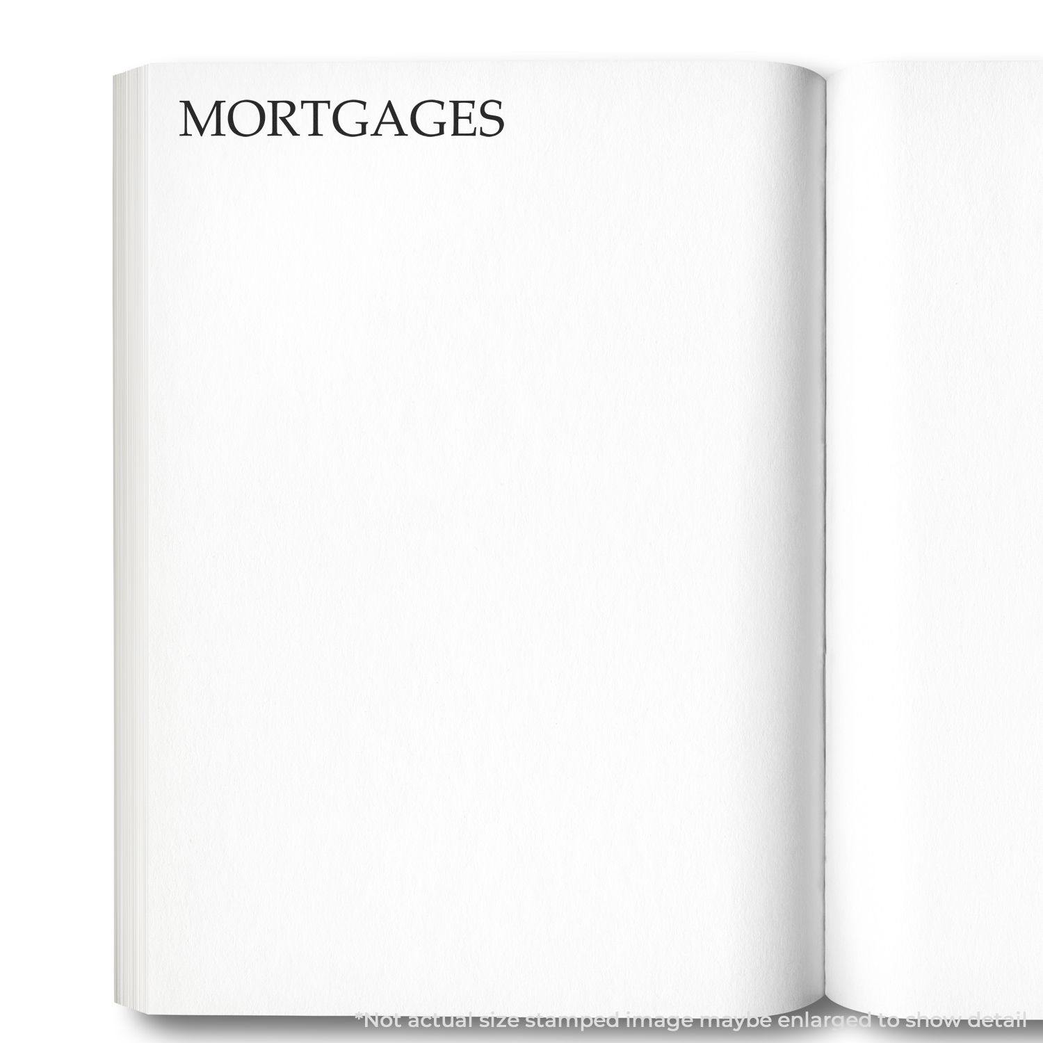 Open book with the word MORTGAGES stamped on a blank page using the Large Mortgages Rubber Stamp.