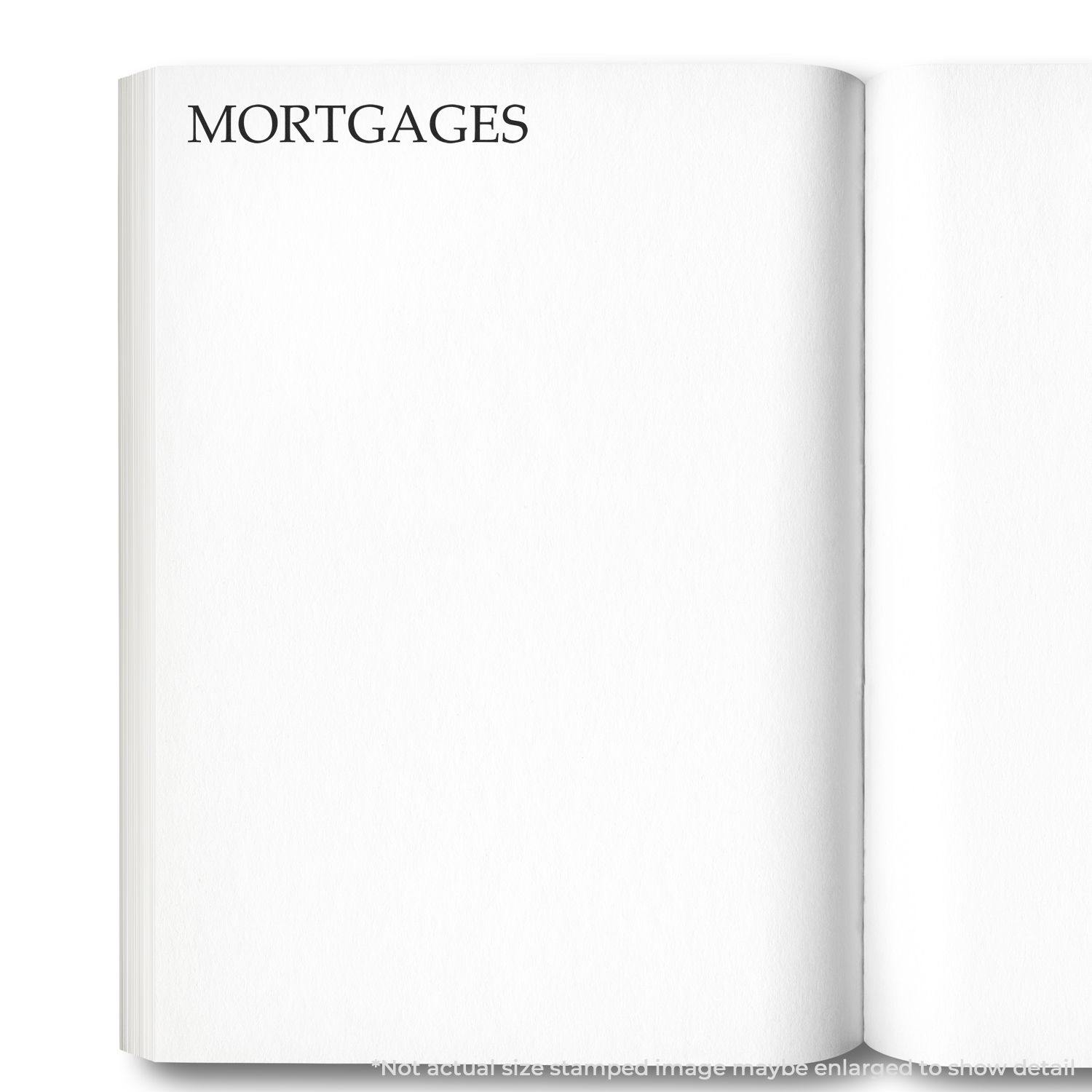 A stock office rubber stamp with a stamped image showing how the text "MORTGAGES" in a large font is displayed after stamping.