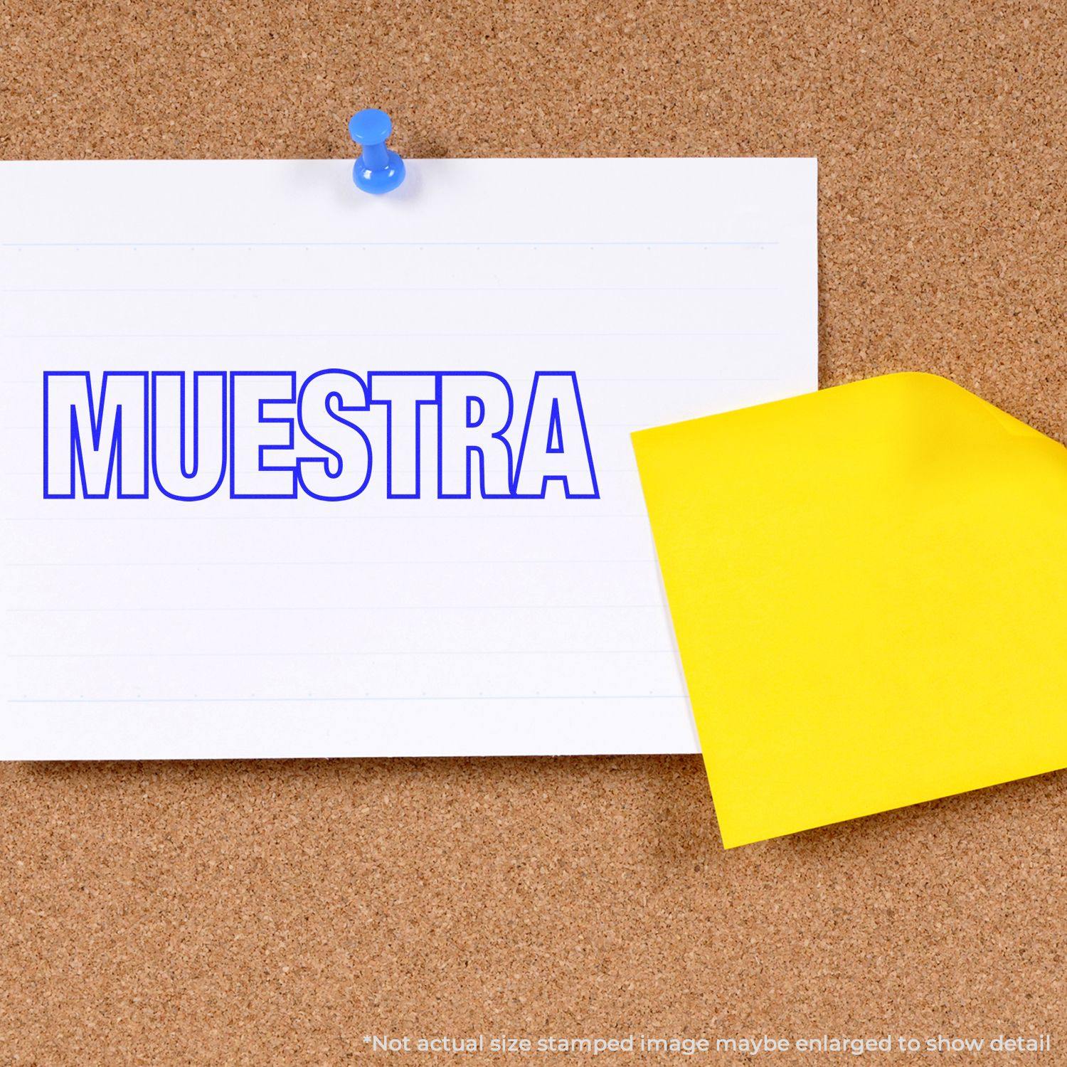 Large Muestra Rubber Stamp used on a white paper pinned to a corkboard, with a yellow sticky note beside it.