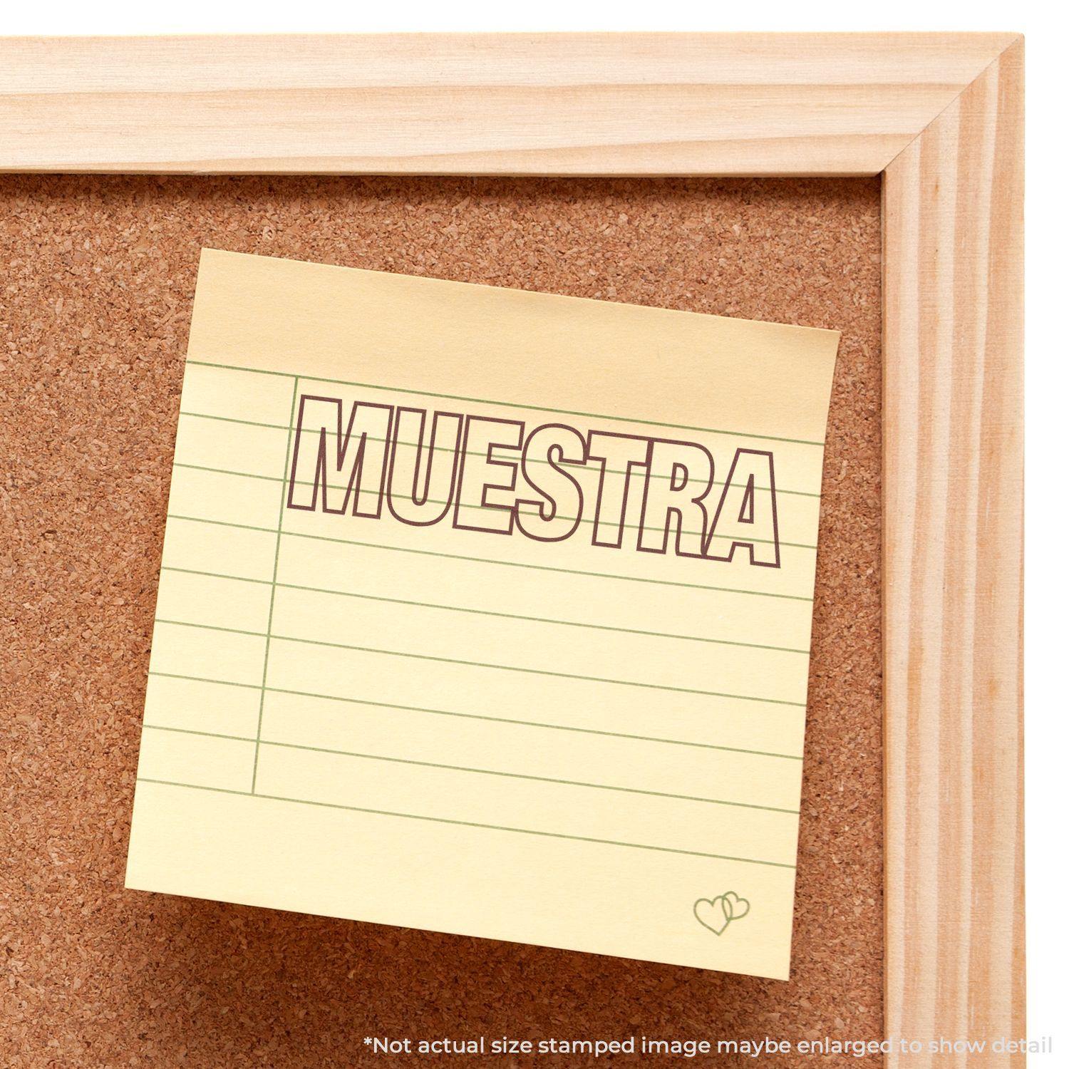 Yellow sticky note with MUESTRA stamped in red ink using the Large Muestra Rubber Stamp, pinned on a corkboard with a wooden frame.