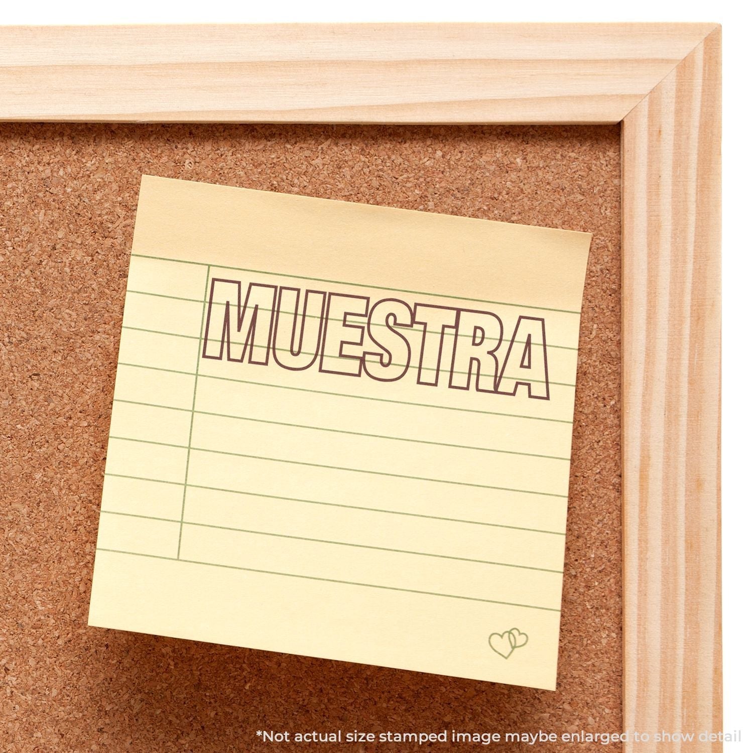 A corkboard with a yellow sticky note stamped with "MUESTRA" using the Self Inking Muestra Stamp.