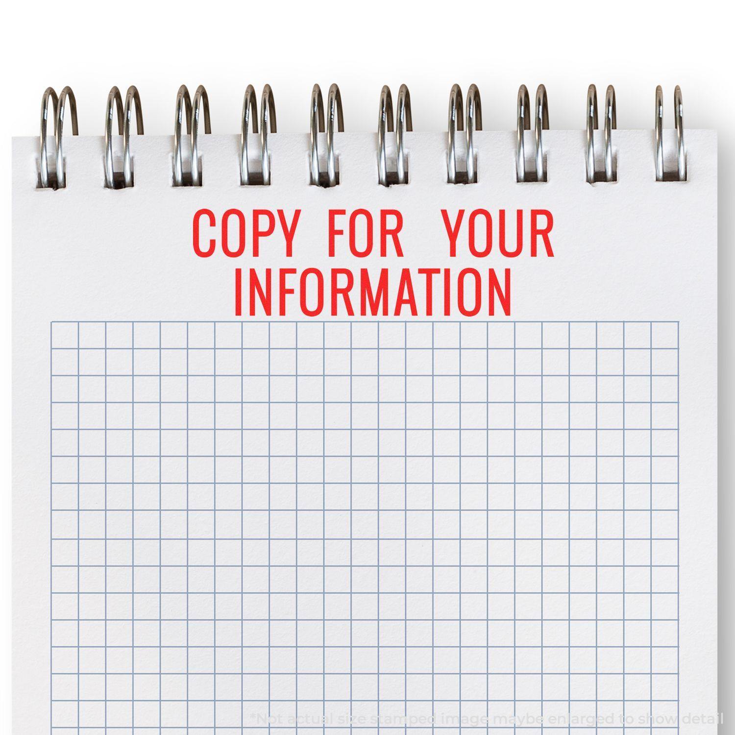 A notebook with a grid pattern and the text COPY FOR YOUR INFORMATION stamped in red using the Large Narrow Copy for your Information Rubber Stamp.