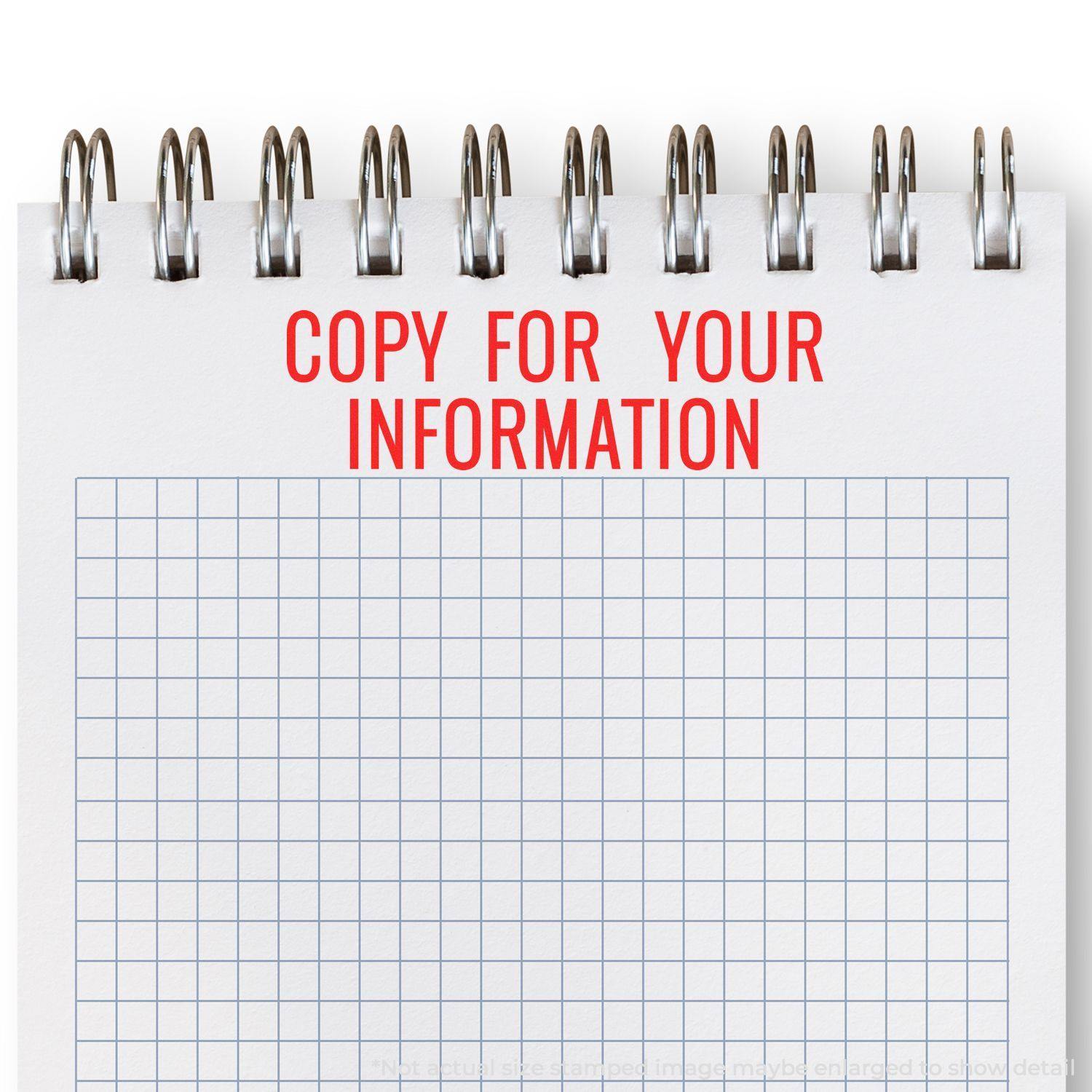 Slim Pre-Inked Narrow Copy for your Information Stamp in red ink on a spiral-bound notepad with a grid pattern.