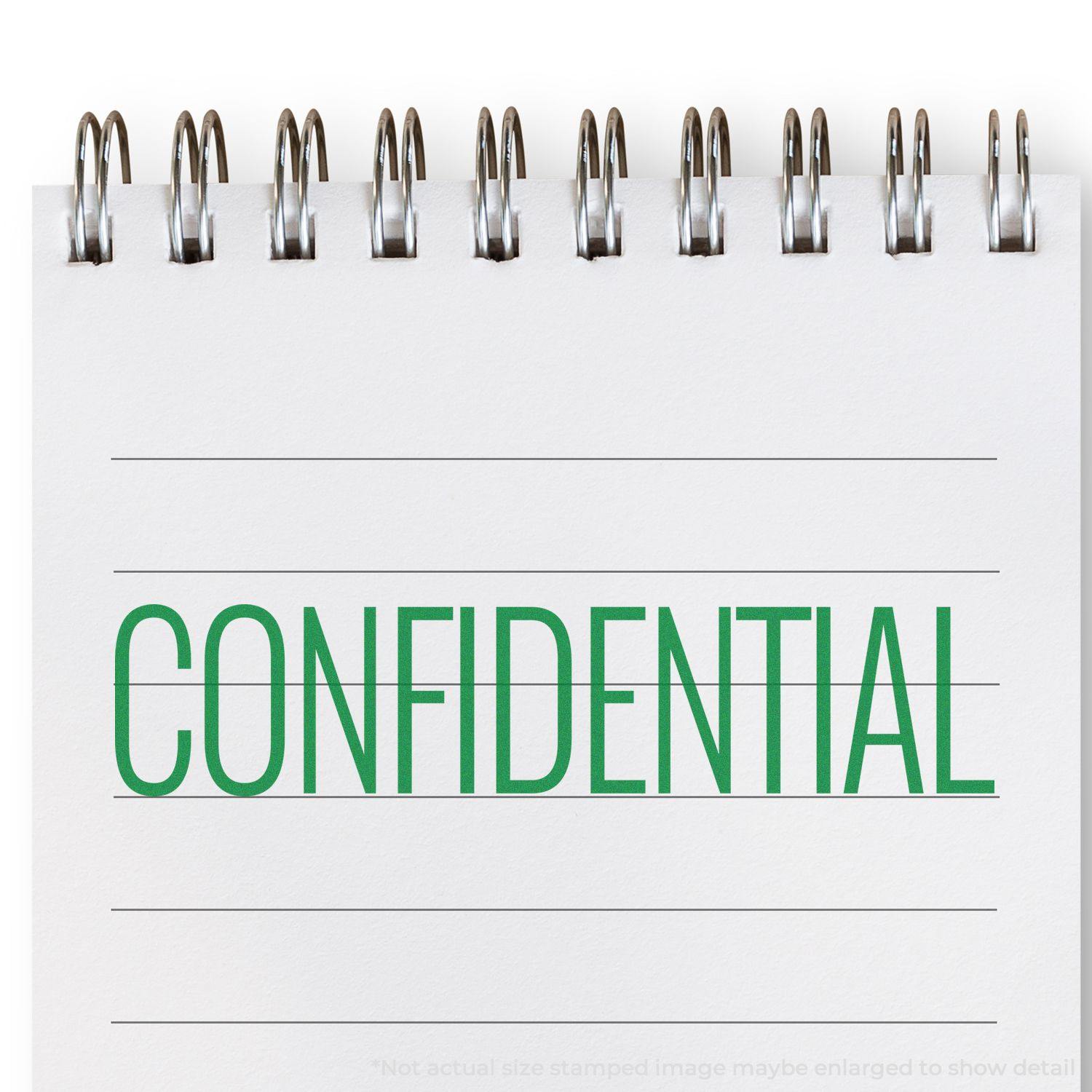 A notebook with CONFIDENTIAL stamped in green using the Large Narrow Font Confidential Rubber Stamp.