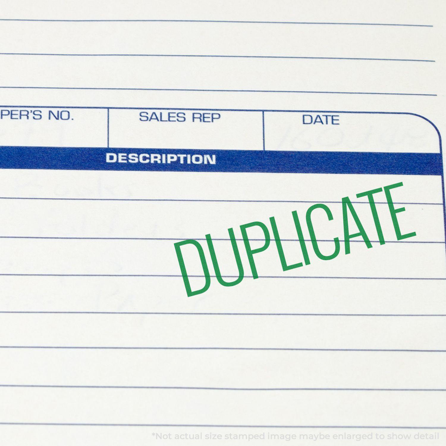 A document stamped with DUPLICATE in green ink using the Large Self Inking Narrow Font Duplicate Stamp.