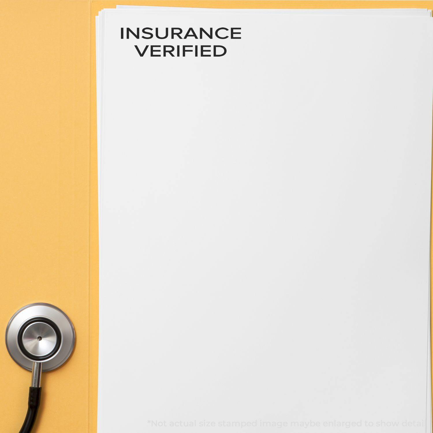 Narrow Font Insurance Verified Rubber Stamp on a white document next to a stethoscope on a yellow background.