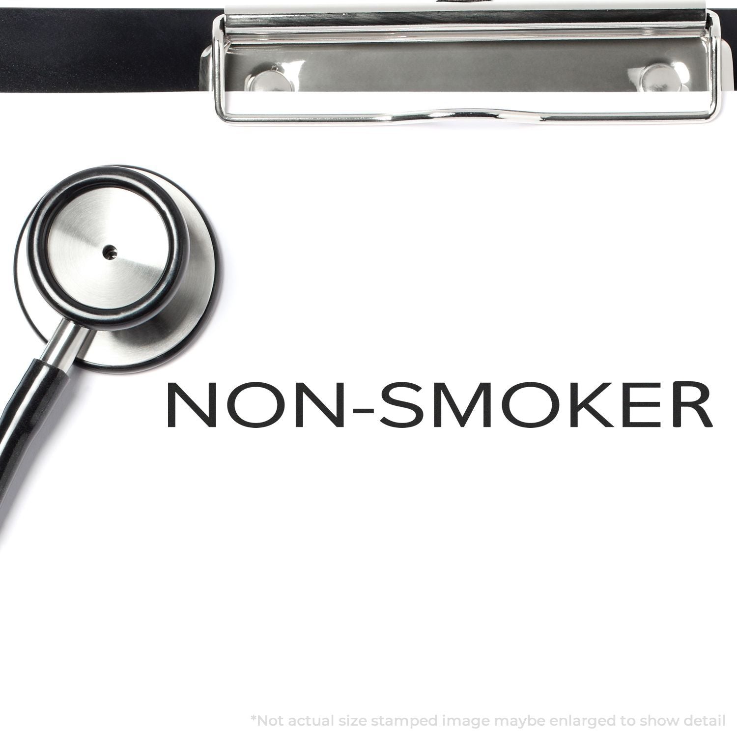 Self Inking Narrow Font Non-Smoker Stamp on a white paper with a stethoscope and clipboard in the background.