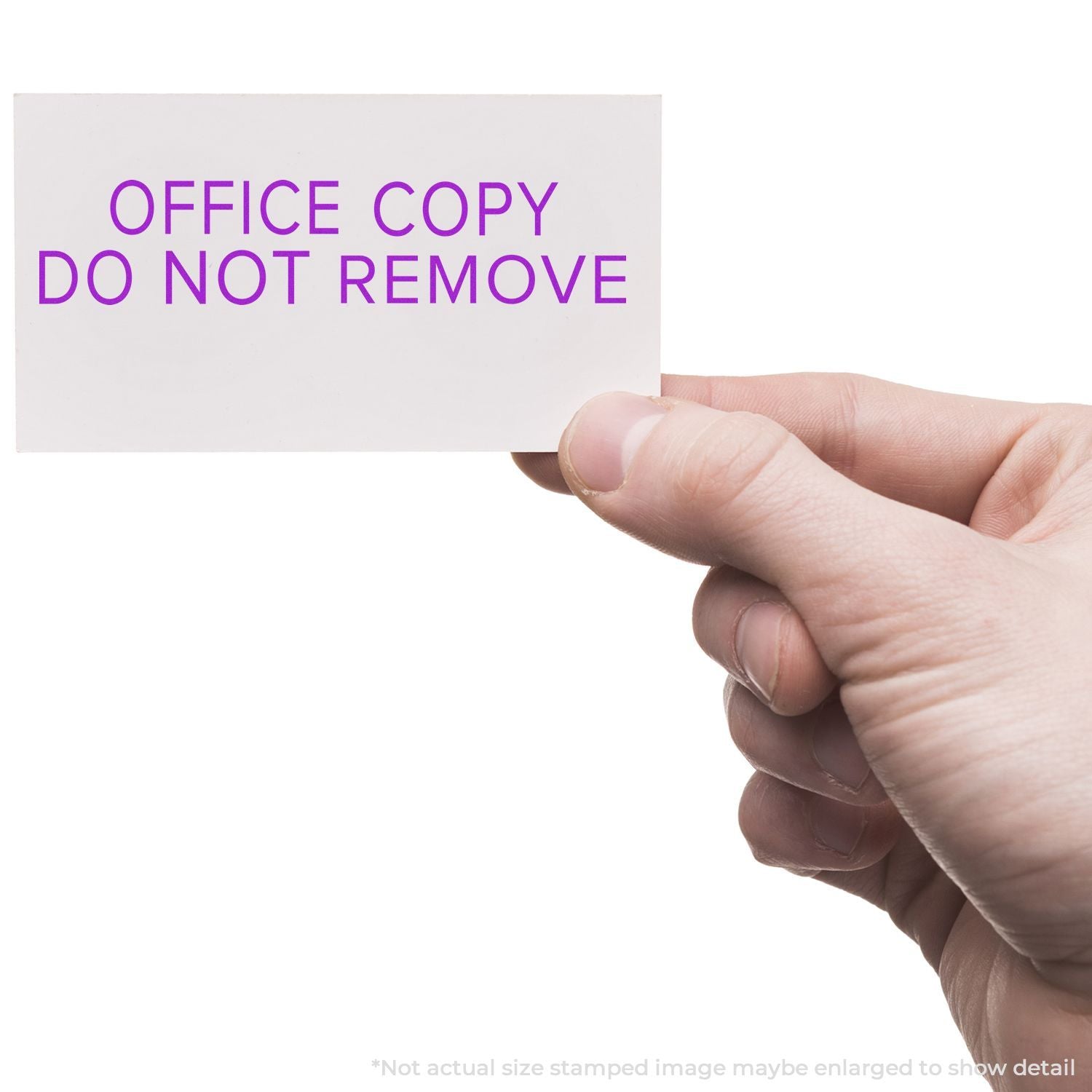 A hand holding a card stamped with OFFICE COPY DO NOT REMOVE using the Self Inking Narrow Font Office Copy Do Not Remove Stamp.