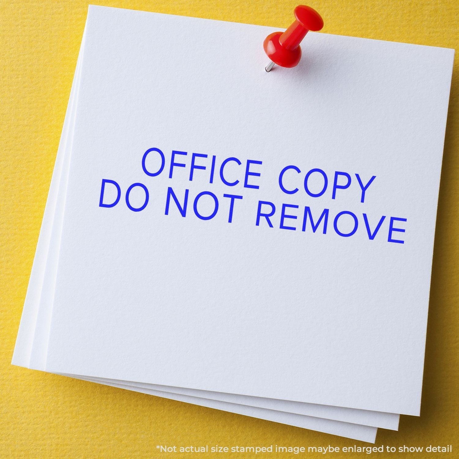 Self Inking Narrow Font Office Copy Do Not Remove Stamp used on white paper pinned with a red pushpin against a yellow background.