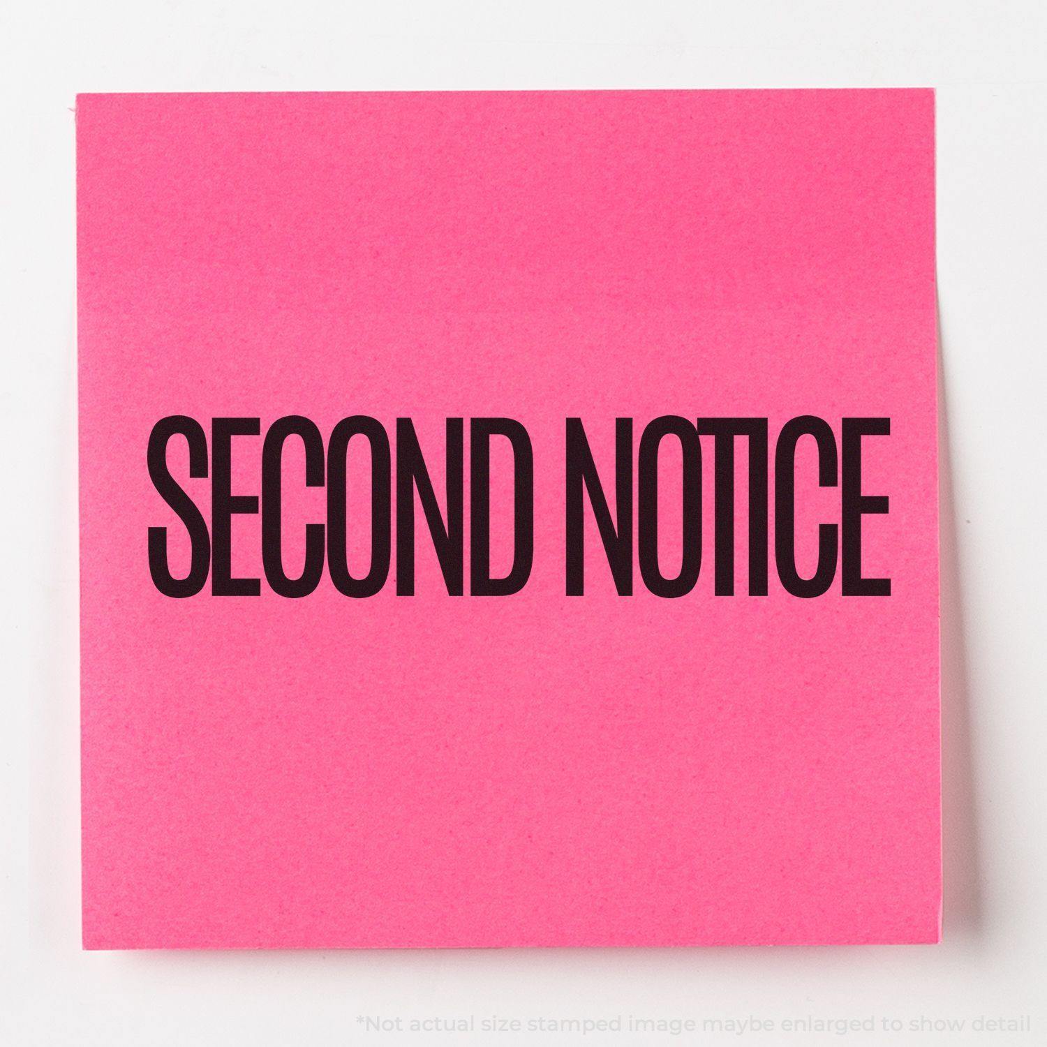 A pink paper stamped with SECOND NOTICE in bold black letters using the Large Narrow Font Second Notice Rubber Stamp.