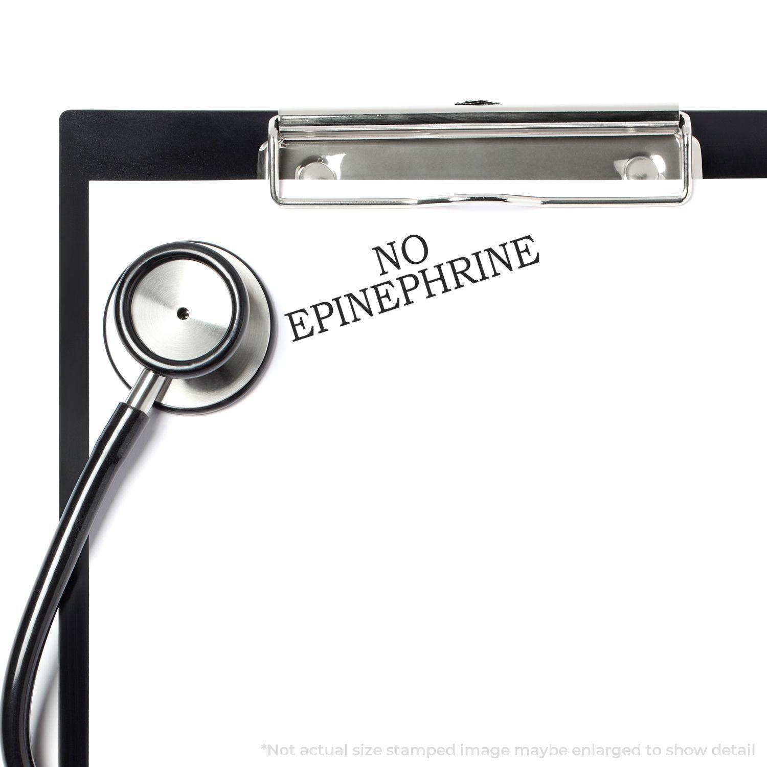 Slim Pre-Inked No Epinephrine Stamp used on a clipboard with a stethoscope beside it.