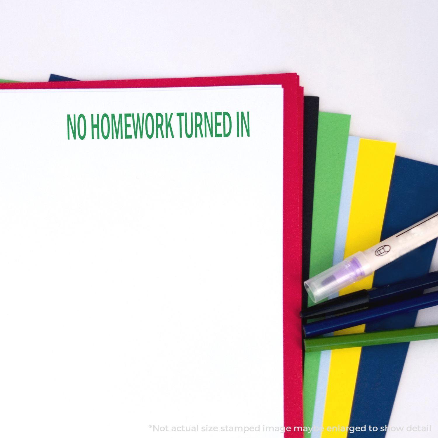 No Homework Turned In Rubber Stamp on a stack of colorful papers with pens and a highlighter nearby.