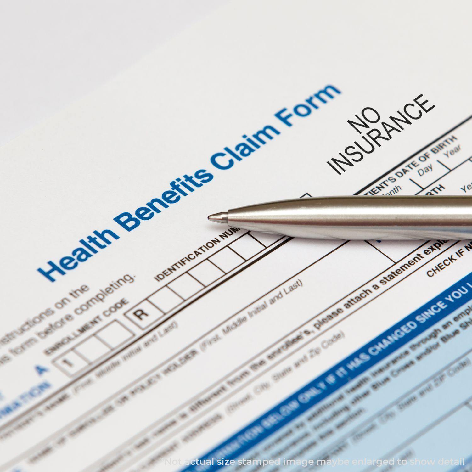 Health Benefits Claim Form stamped with a Slim Pre-Inked No Insurance Stamp, with a pen pointing at the stamped area.