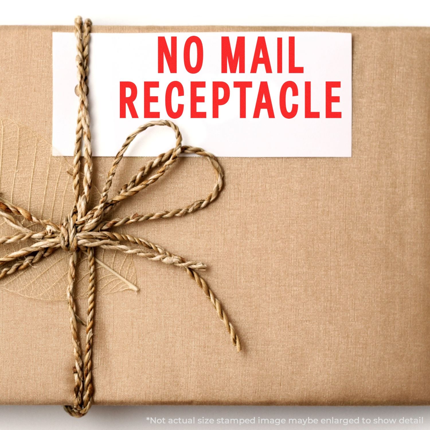 Self Inking No Mail Receptacle Stamp used on a brown package tied with twine, displaying a clear NO MAIL RECEPTACLE message in red.