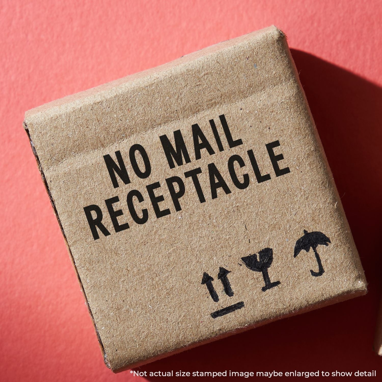 A cardboard box stamped with NO MAIL RECEPTACLE using the Self Inking No Mail Receptacle Stamp on a red background.