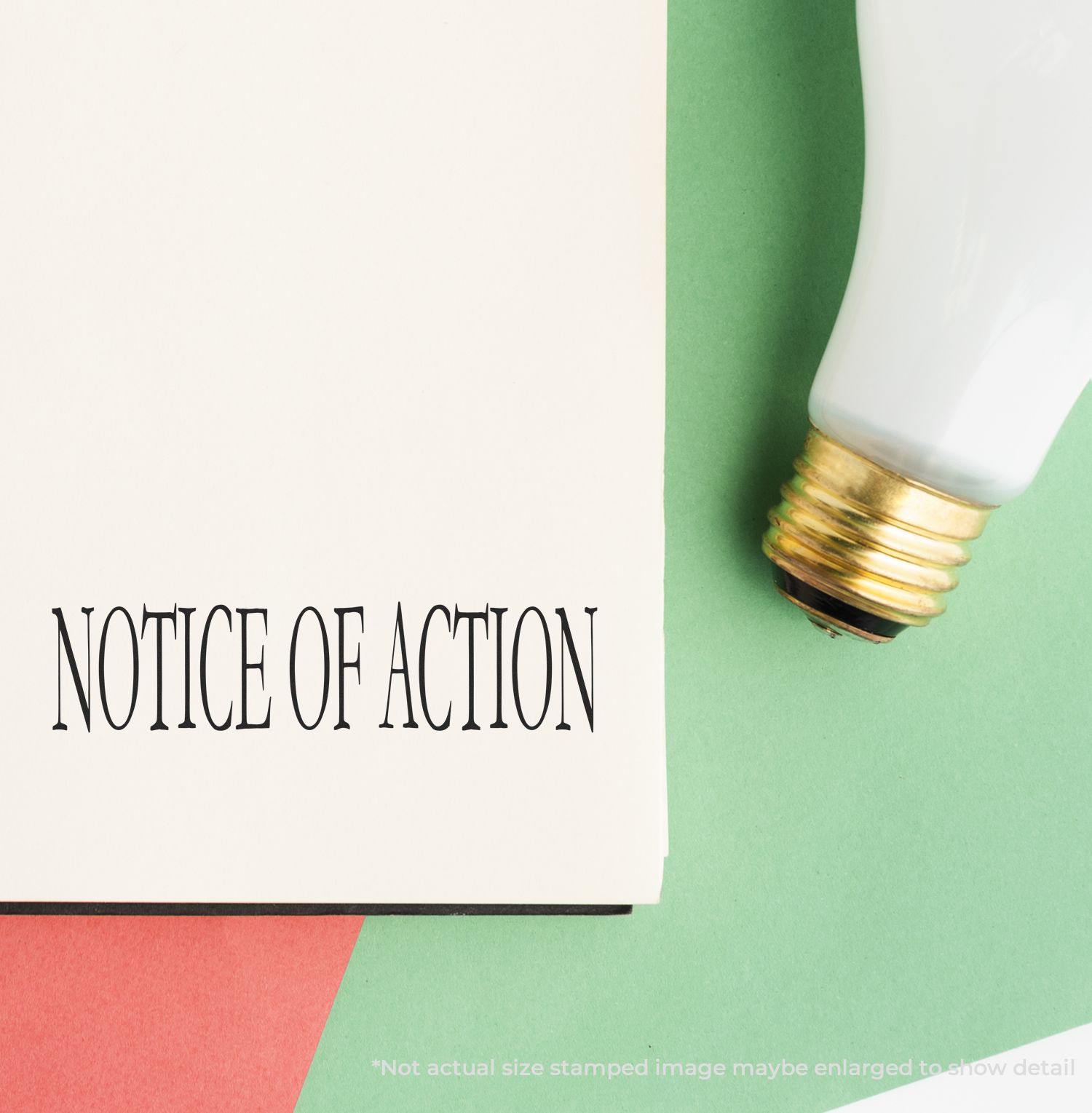 Large Notice Of Action Rubber Stamp imprint on paper, next to a light bulb on a green and red background.