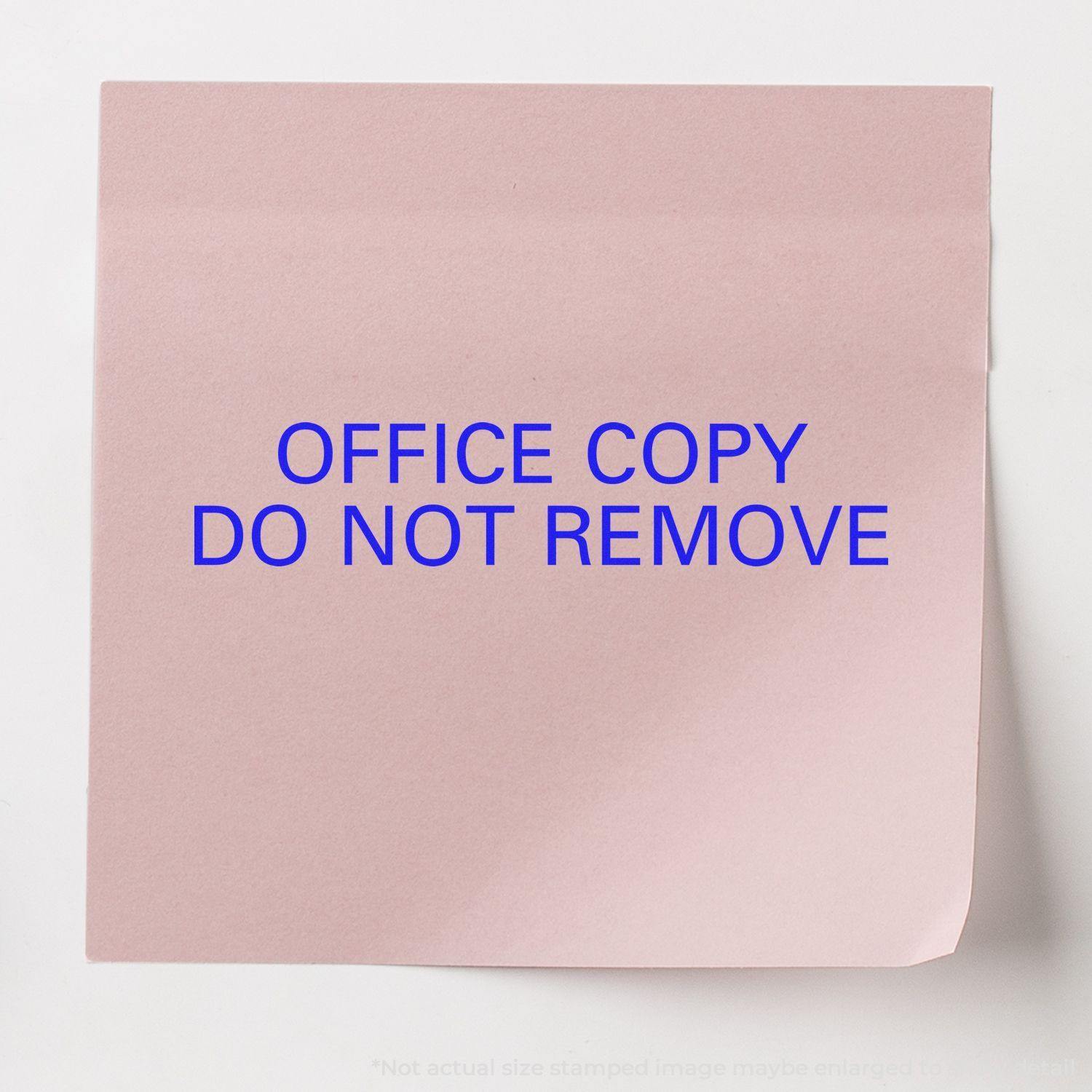 Slim Pre-Inked Office Copy Do Not Remove Stamp used on a pink paper, displaying the text OFFICE COPY DO NOT REMOVE in blue.