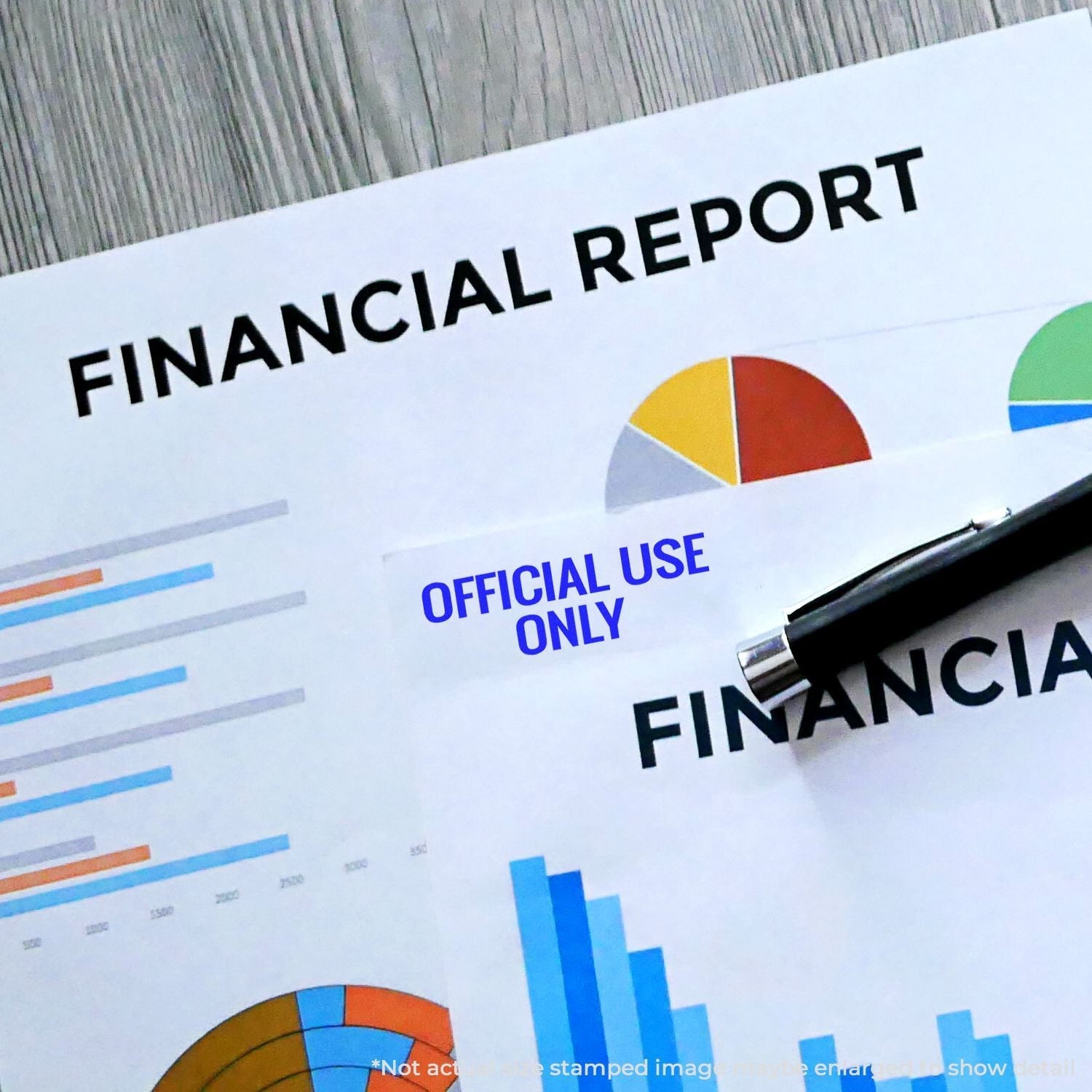 Financial reports stamped with Self Inking Official Use Only Stamp in blue ink, accompanied by a pen on a wooden surface.