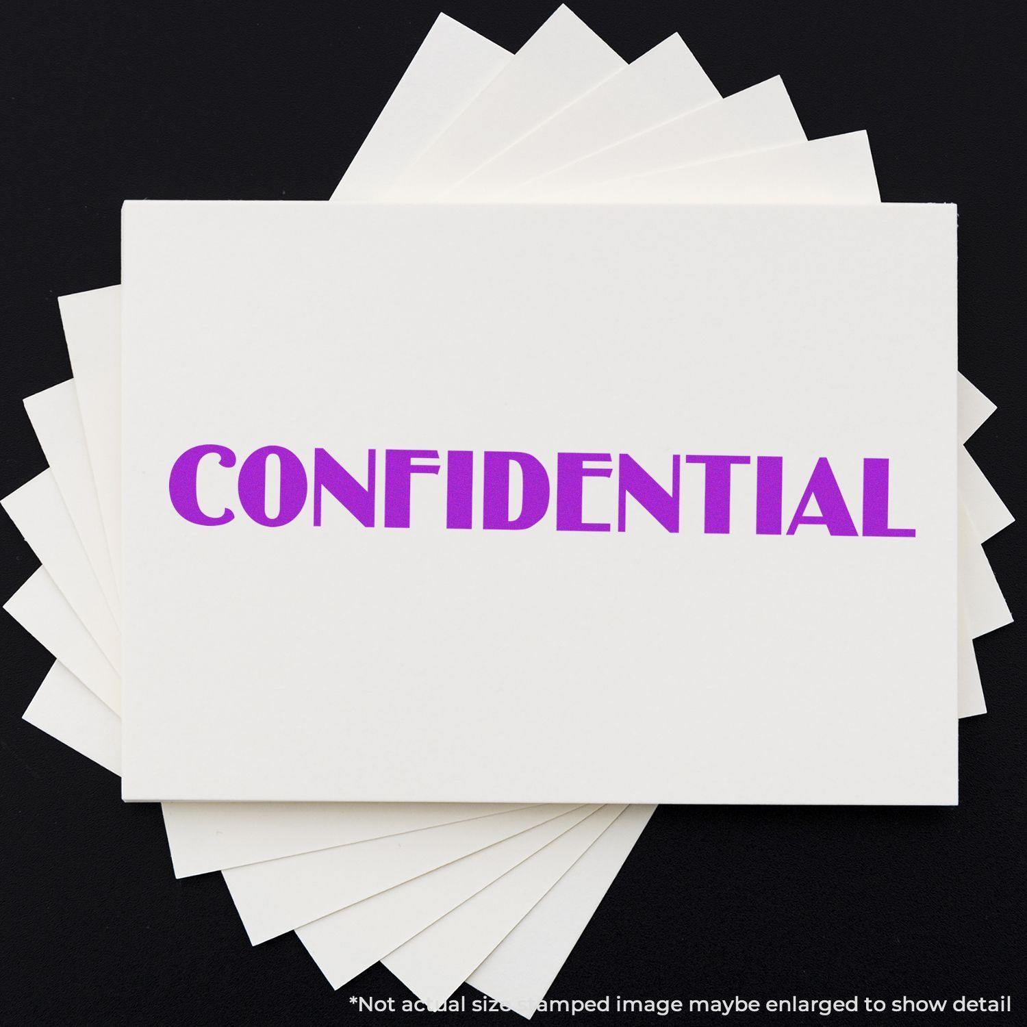 Large Pre-Inked Optima Confidential Stamp in use, displaying the word CONFIDENTIAL in bold purple letters on white paper.