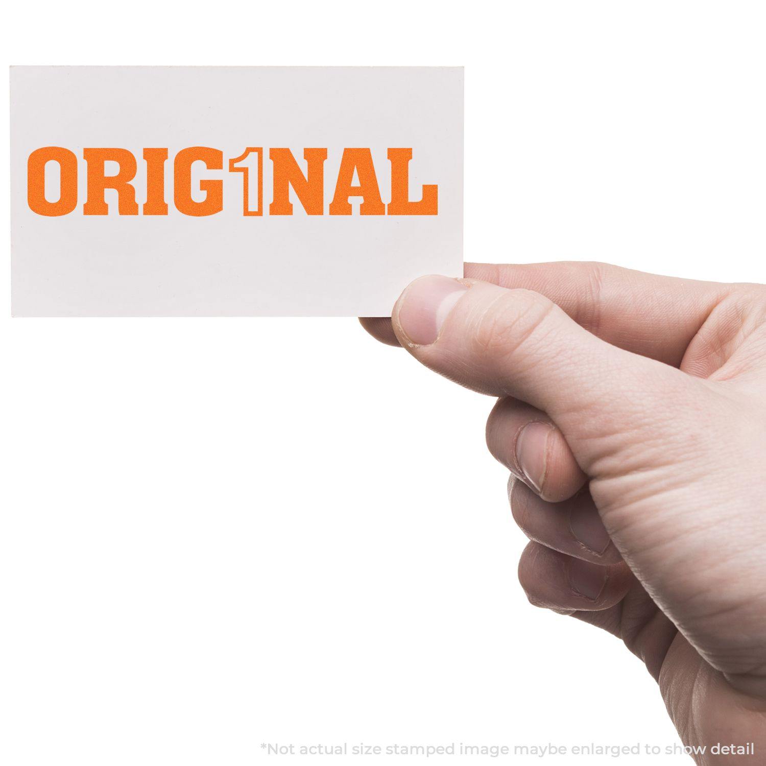 Hand holding a white card with Orig1nal stamped in bold orange letters, showcasing the Orig1nal Rubber Stamp in use.